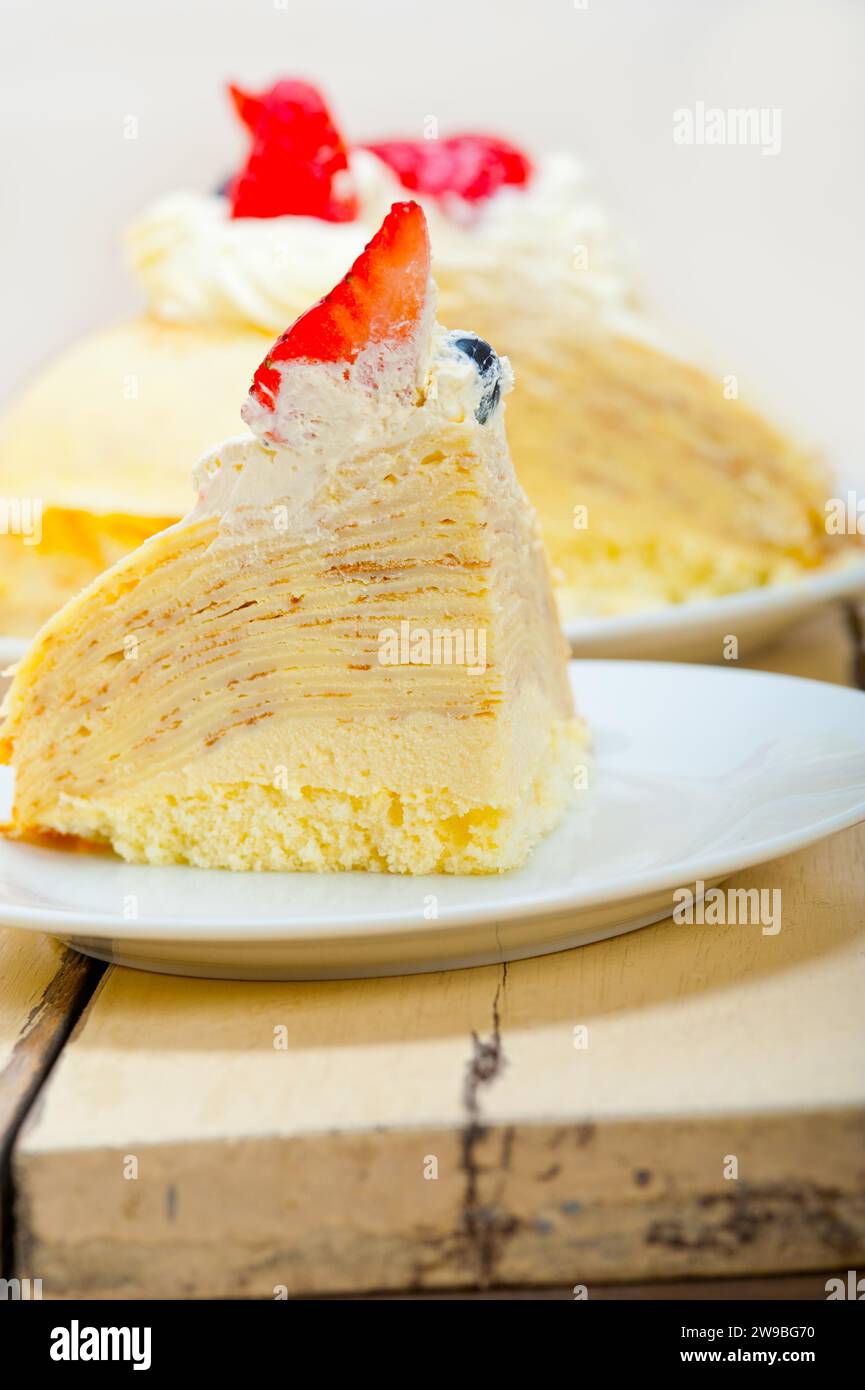 Crepe pancake cake with whipped cream and strawberry on top, food photography Stock Photo