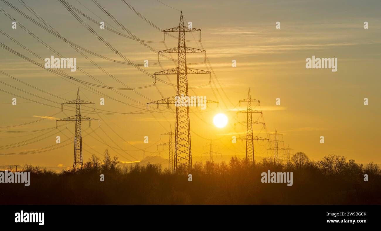 High-voltage pylons, overhead power lines, power lines, in the morning, sunrise, sun, Baden-Württemberg, Germany, Europe Stock Photo