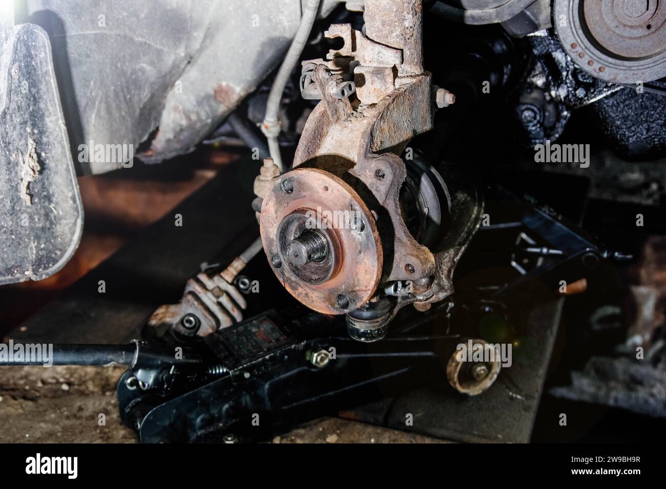 Car hub replacement, car repair, mechanic, glove, screws, motor