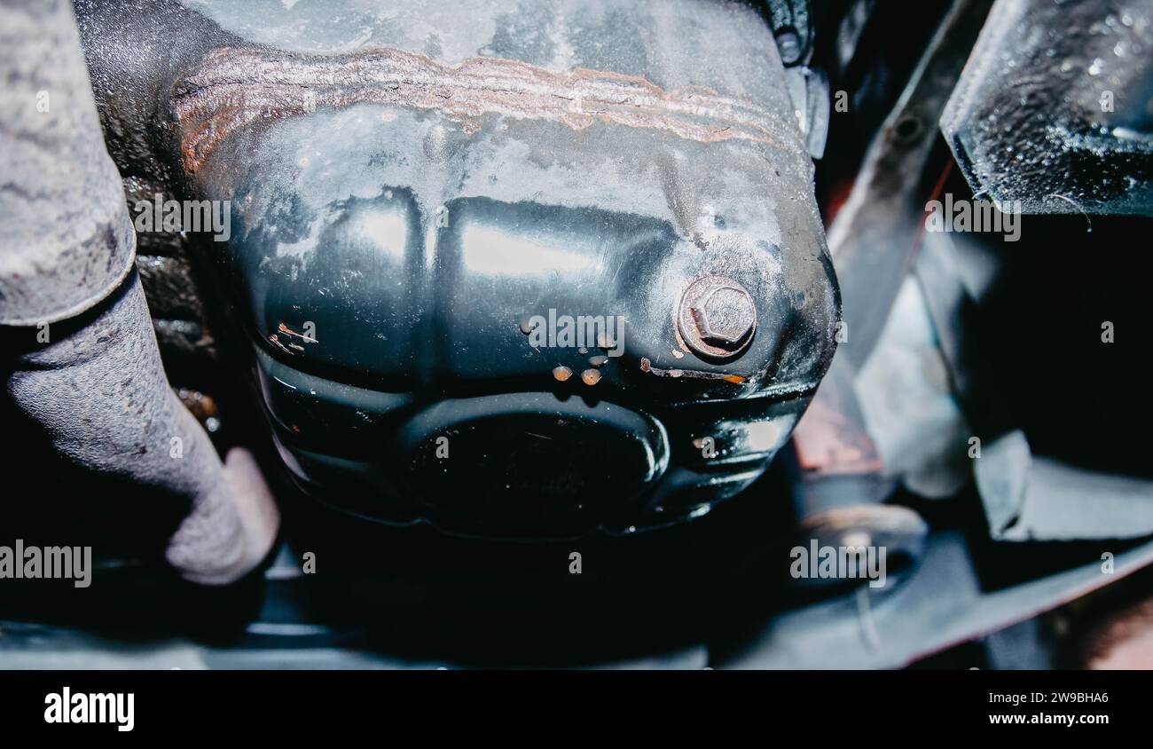 Car engine oil pan closeup, car repair, mechanic, glove, screws, motor, Stock Photo