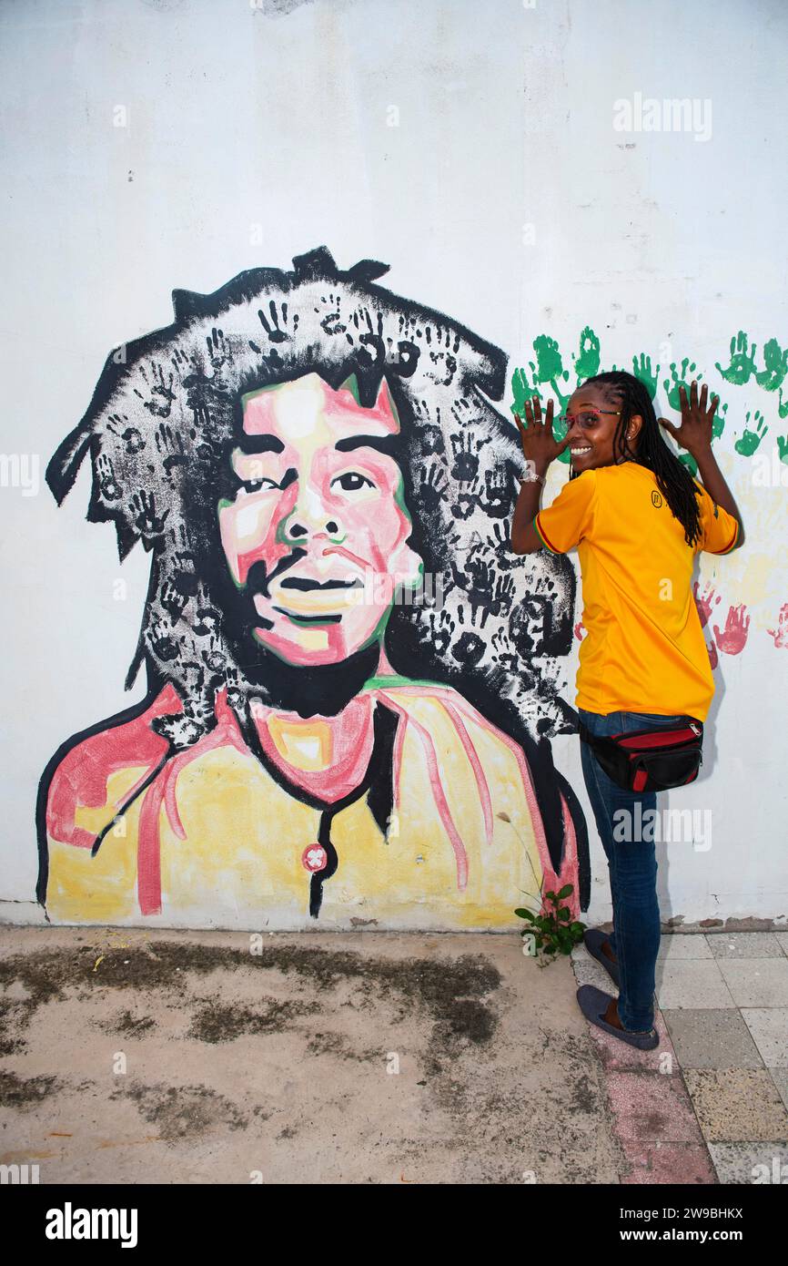 Tour guide Susan Maxwell in front of Bob Marley mural, Tuff Gong music