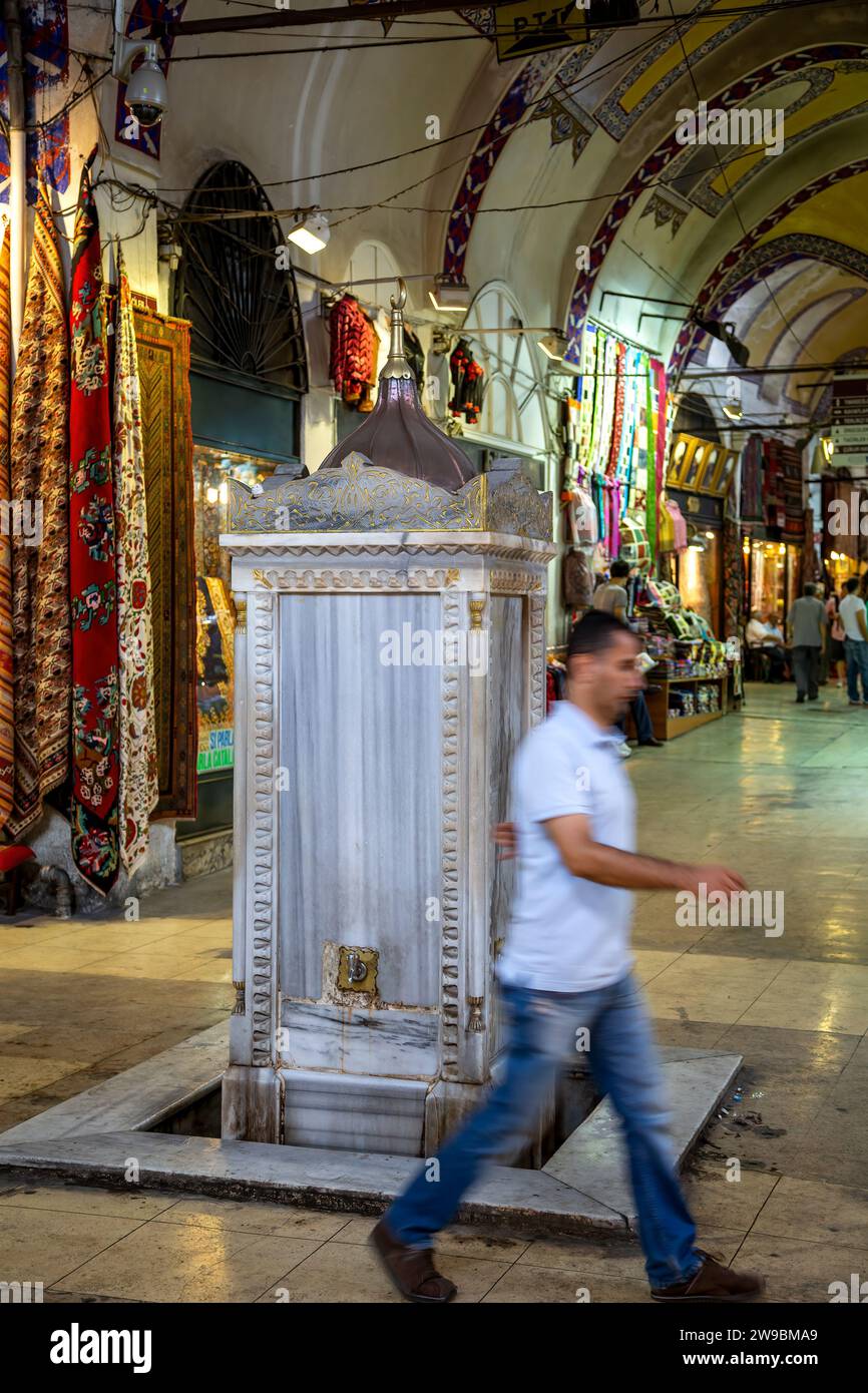 Man walking in front of ablution fountain, Grand Bazaar, Istanbul, Turkey Stock Photo
