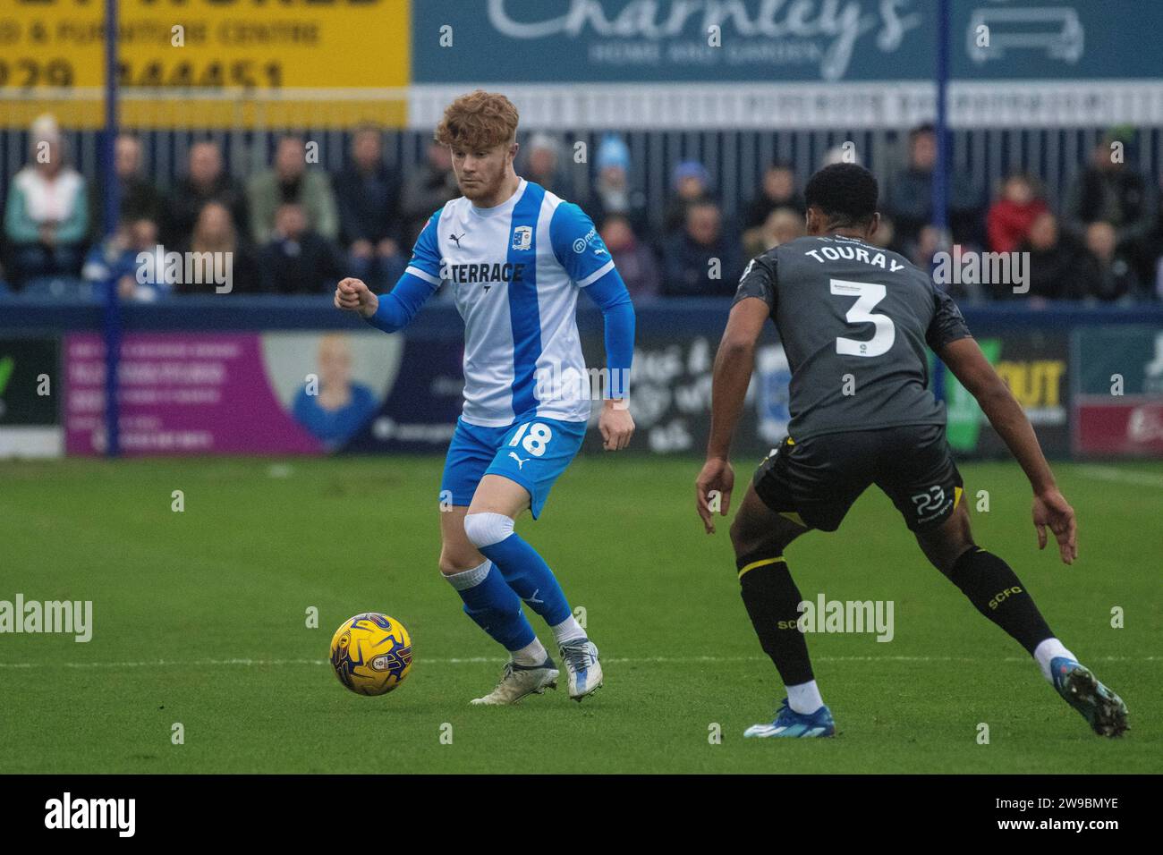 Barrow's Luca Stephenson in action with Stockport County's Ibou Touray ...