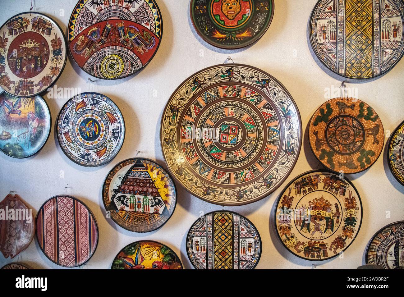 Handmade plates and bowls hanging on a wall in a shop in Cusco, Peru Stock Photo