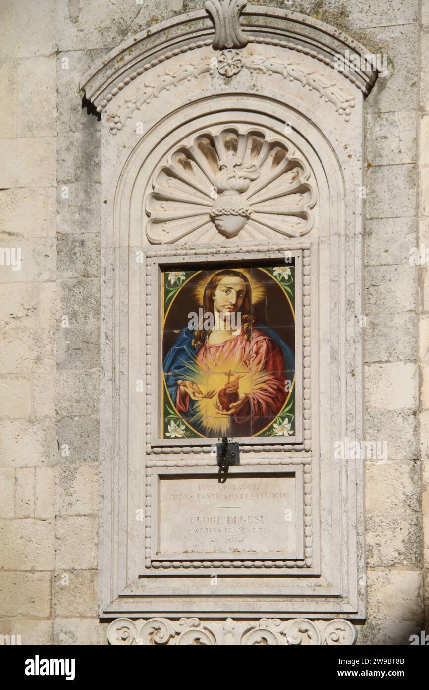 Martina Franca, Italy. An image of the 'Sacred Heart of Jesus' on the exterior of the Church of St. Martin of Tours. Stock Photo