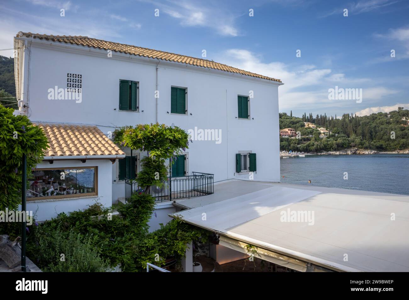 Durrell white house. Place where was living famous british writer Laurence Durrell. White facade and traditional windows with shutters. Blue sky with Stock Photo