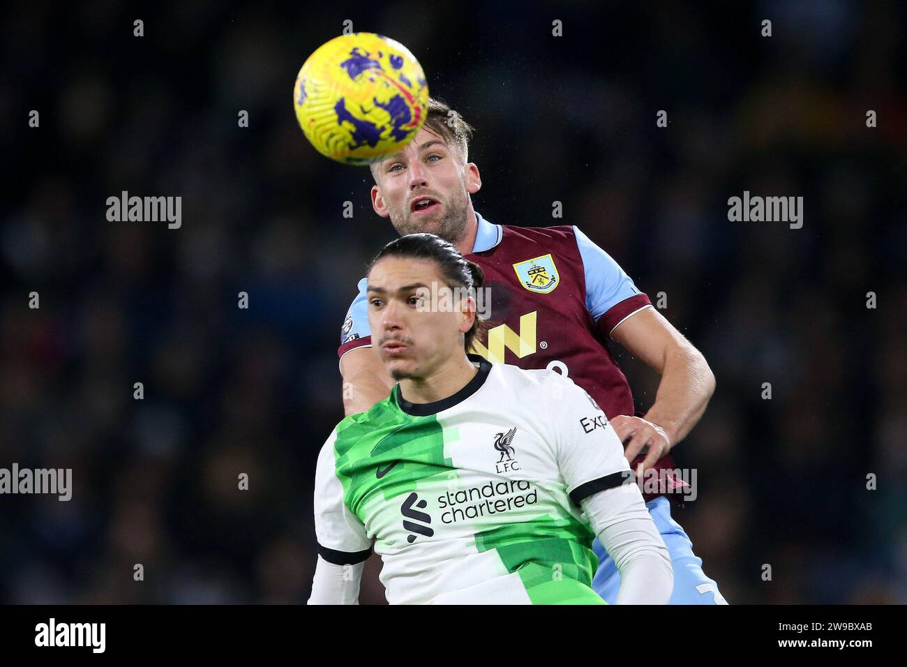 Burnley, UK. 26th Dec, 2023. Charlie Taylor of Burnley jumps above Darwin Nunez of Liverpool. Premier League match, Burnley v Liverpool at Turf Moor in Burnley, Lancs on Boxing Day, Tuesday 26th December 2023. this image may only be used for Editorial purposes. Editorial use only, pic by Chris Stading/Andrew Orchard sports photography/Alamy Live news Credit: Andrew Orchard sports photography/Alamy Live News Stock Photo