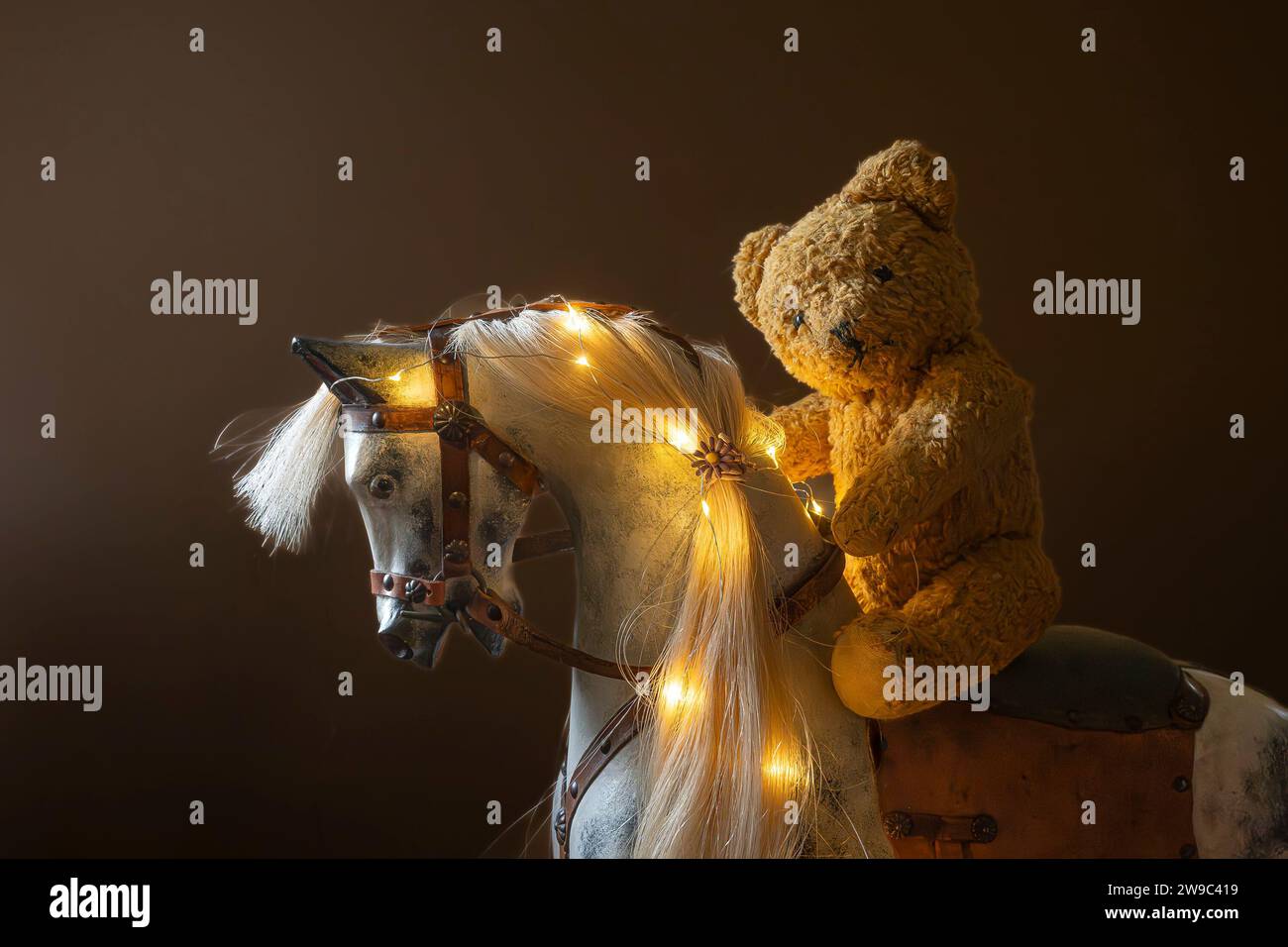 Teddy bear riding Rocking Horse Stock Photo