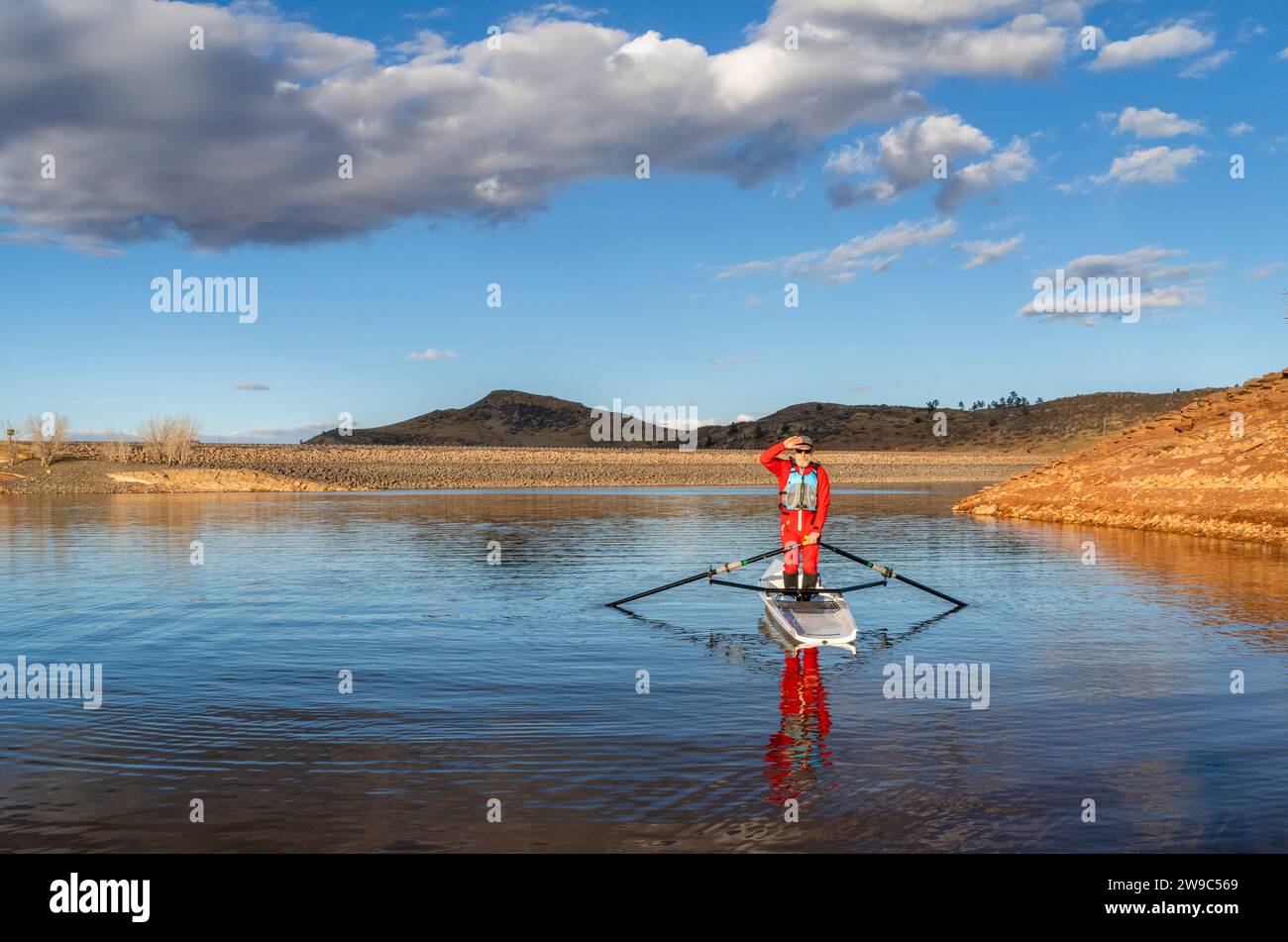 Senior male rower is standing in a coastal rowing shell Horsetooth