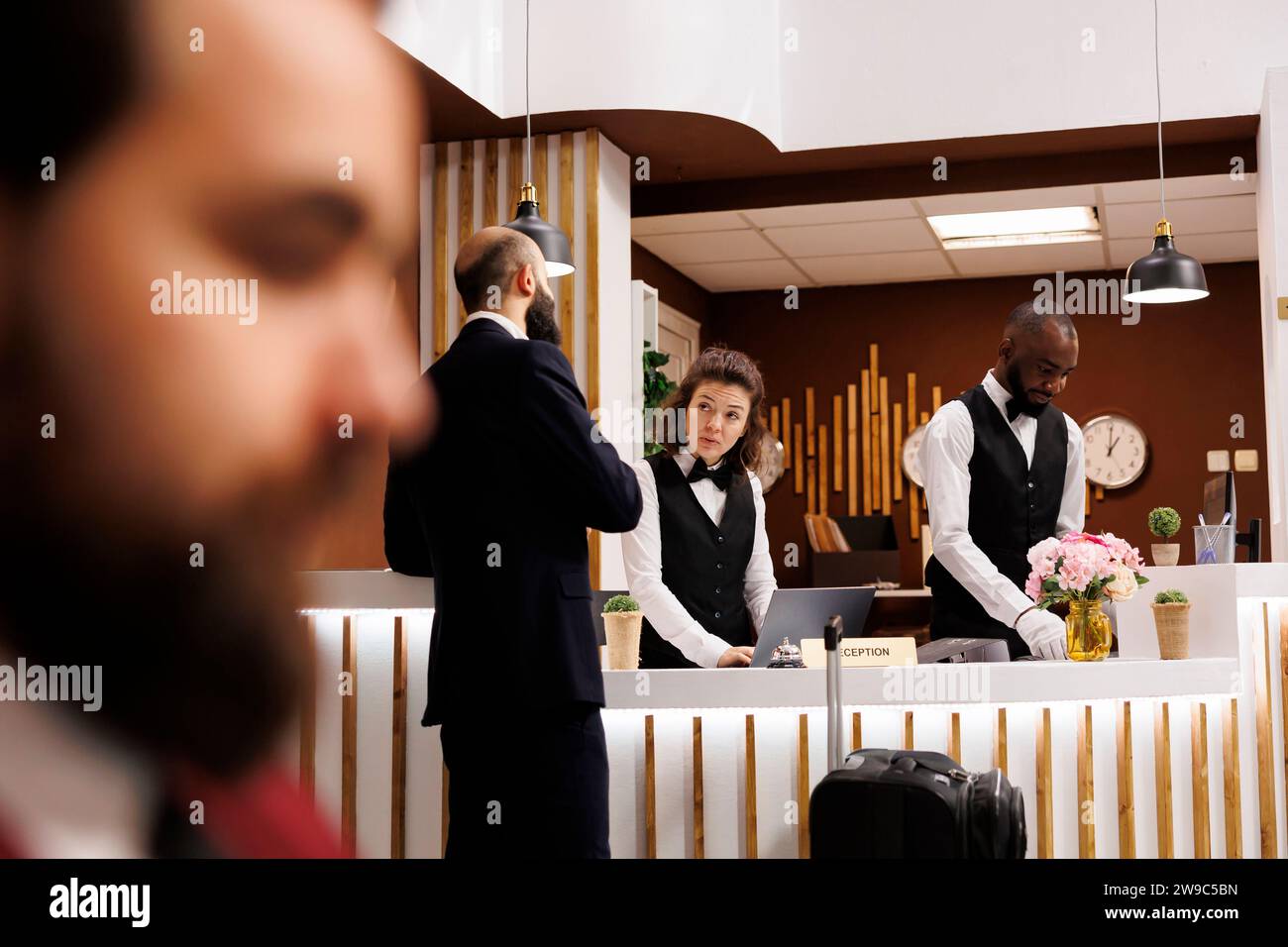 Professional signing registration forms, arriving at hotel with ...