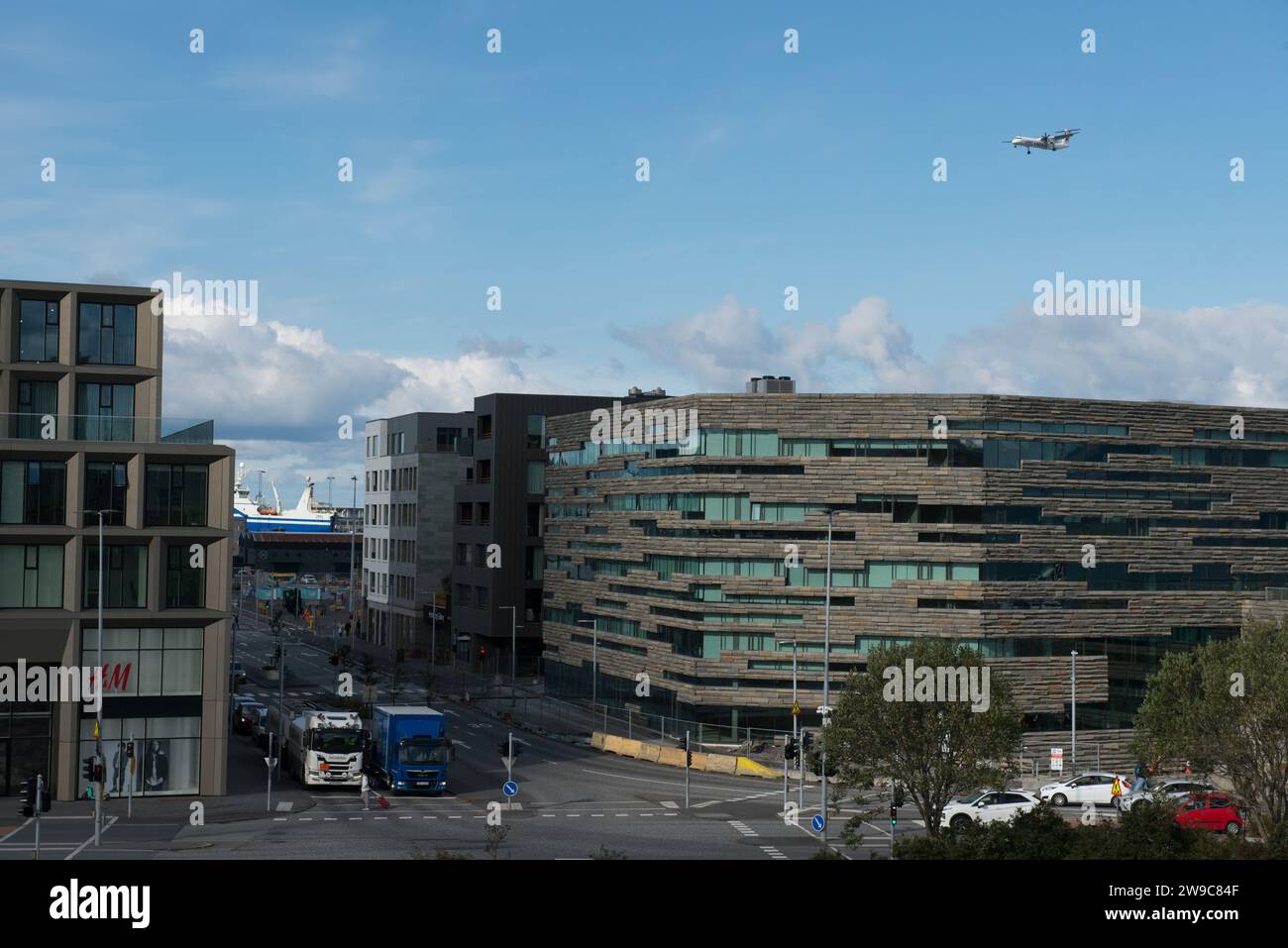 Downtown Reykjavik looking toward the harbor from the Ingólfur Arnarson statue as a plane makes it's approach to the airport in September of 2023. Stock Photo
