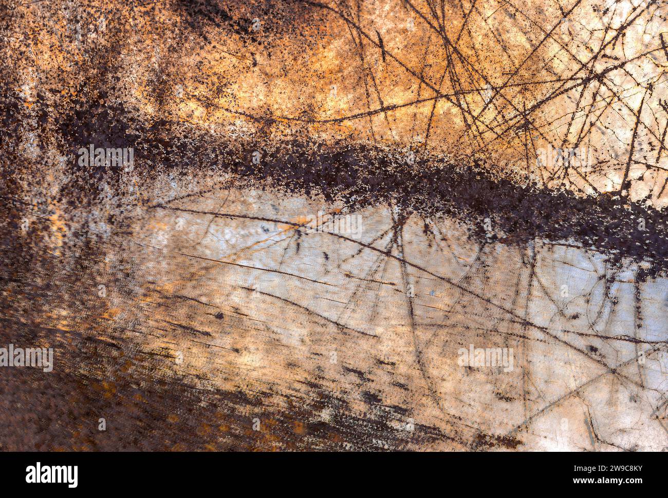 An abstract photograph of a pattern of scratches on a rusted metal surface Stock Photo