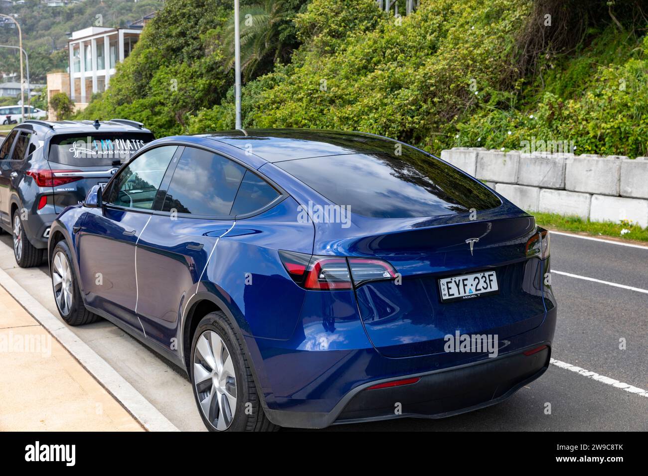 Blue Tesla Model Y parked in Palm Beach,Sydney,Australia in December 2023 Stock Photo