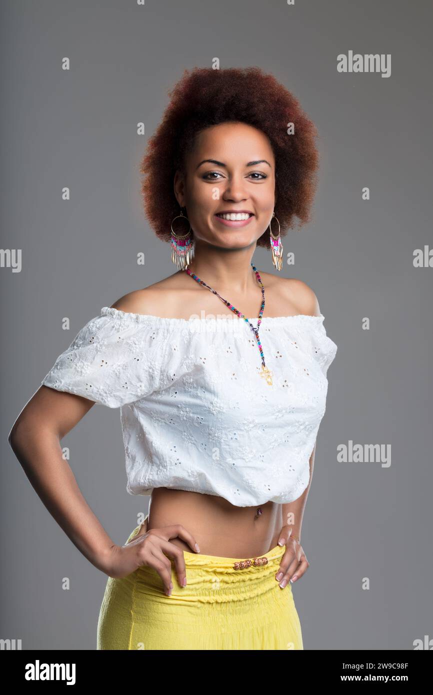 She flaunts a midriffbaring yellow skirt and a delicate white top with