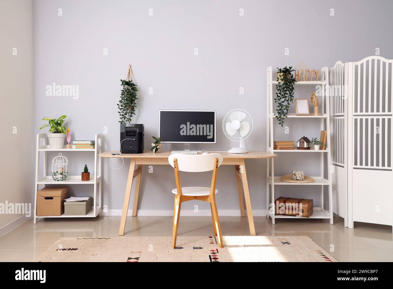 Comfortable workspace with modern computer and portable power station ...