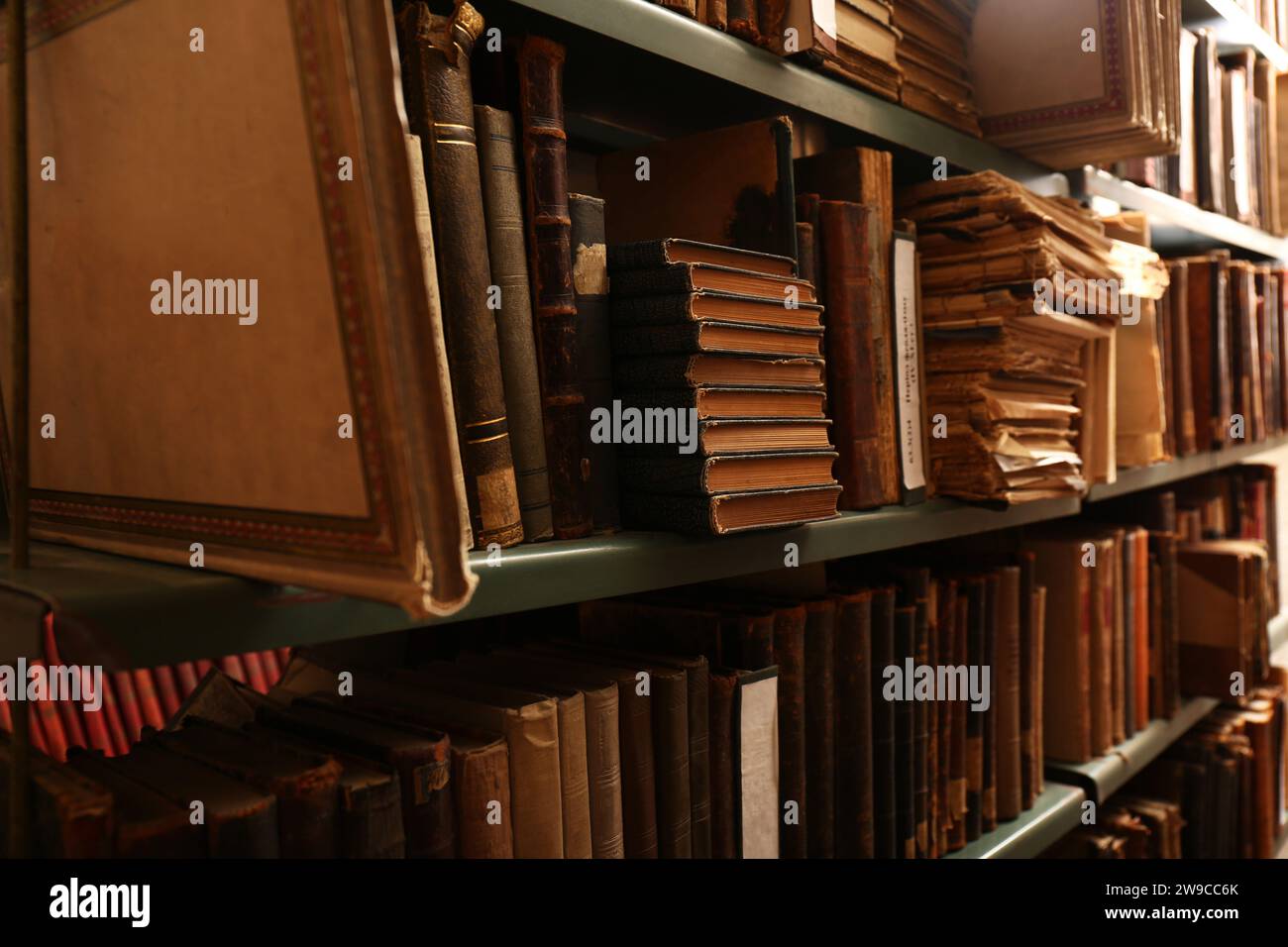 Collection of old books on shelves in library Stock Photo - Alamy