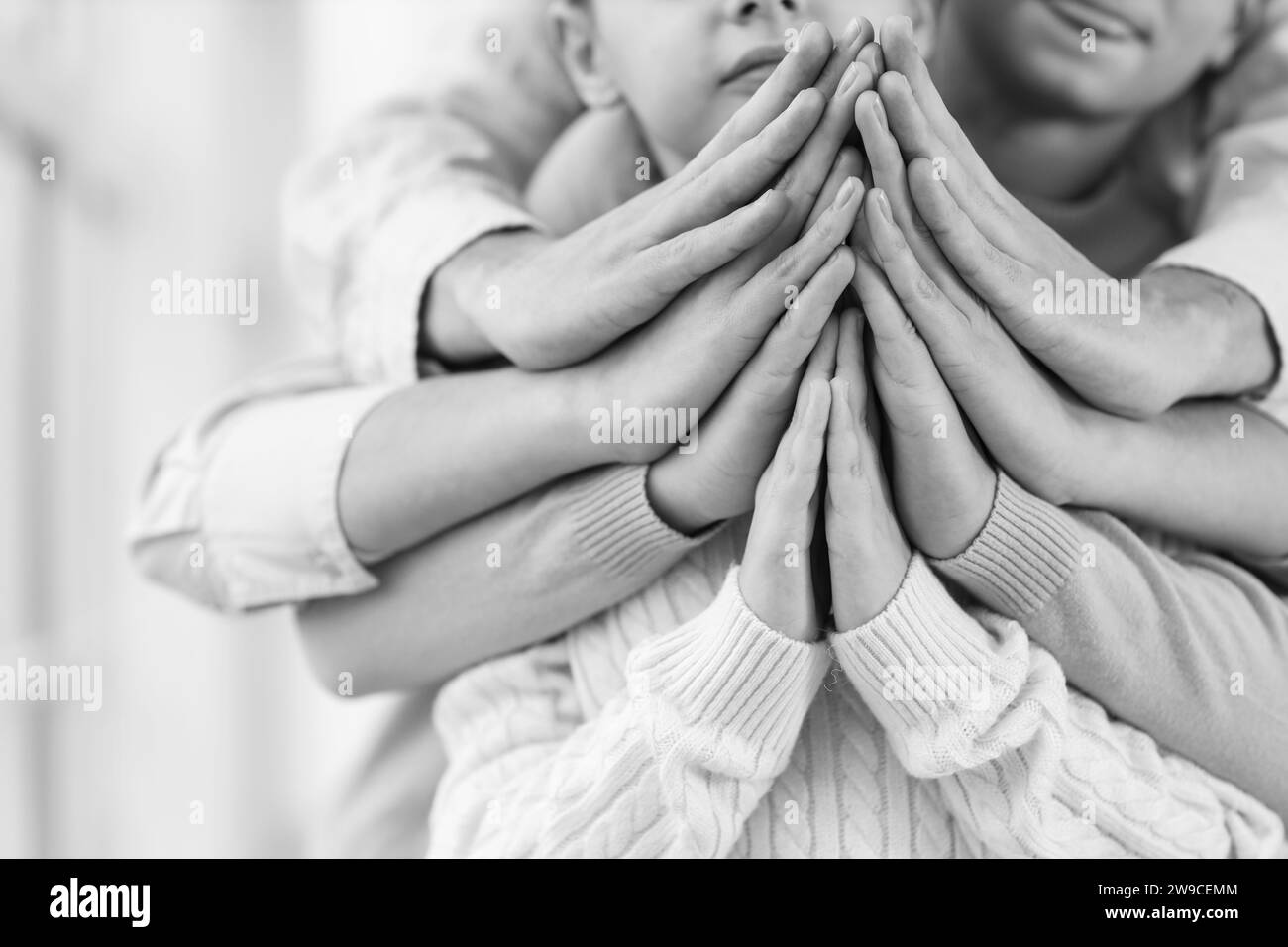 Family praying together at home, closeup Stock Photo
