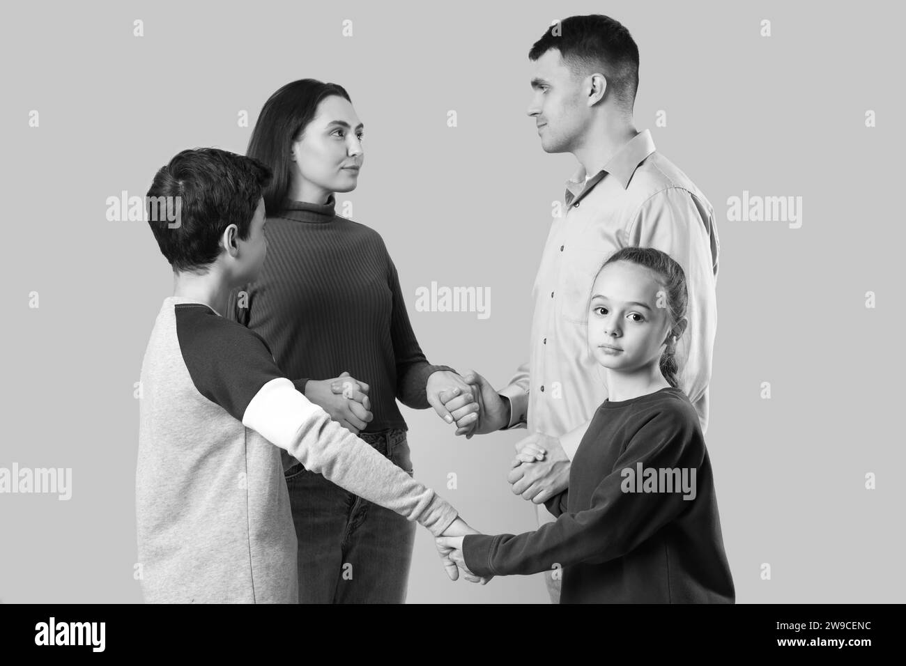 Family praying together on light background Stock Photo