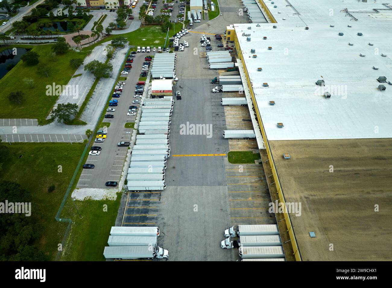 Aerial view of large commercial loading bay with many delivery trucks ...