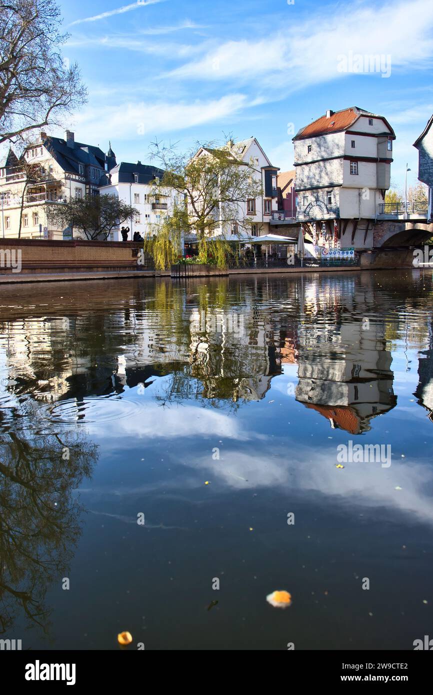 Bad Kreuznach, Germany - April 25, 2021: Historic white buildings and reflection in Nahe River on a spring day in Bad Kreuznach, Germany. Stock Photo