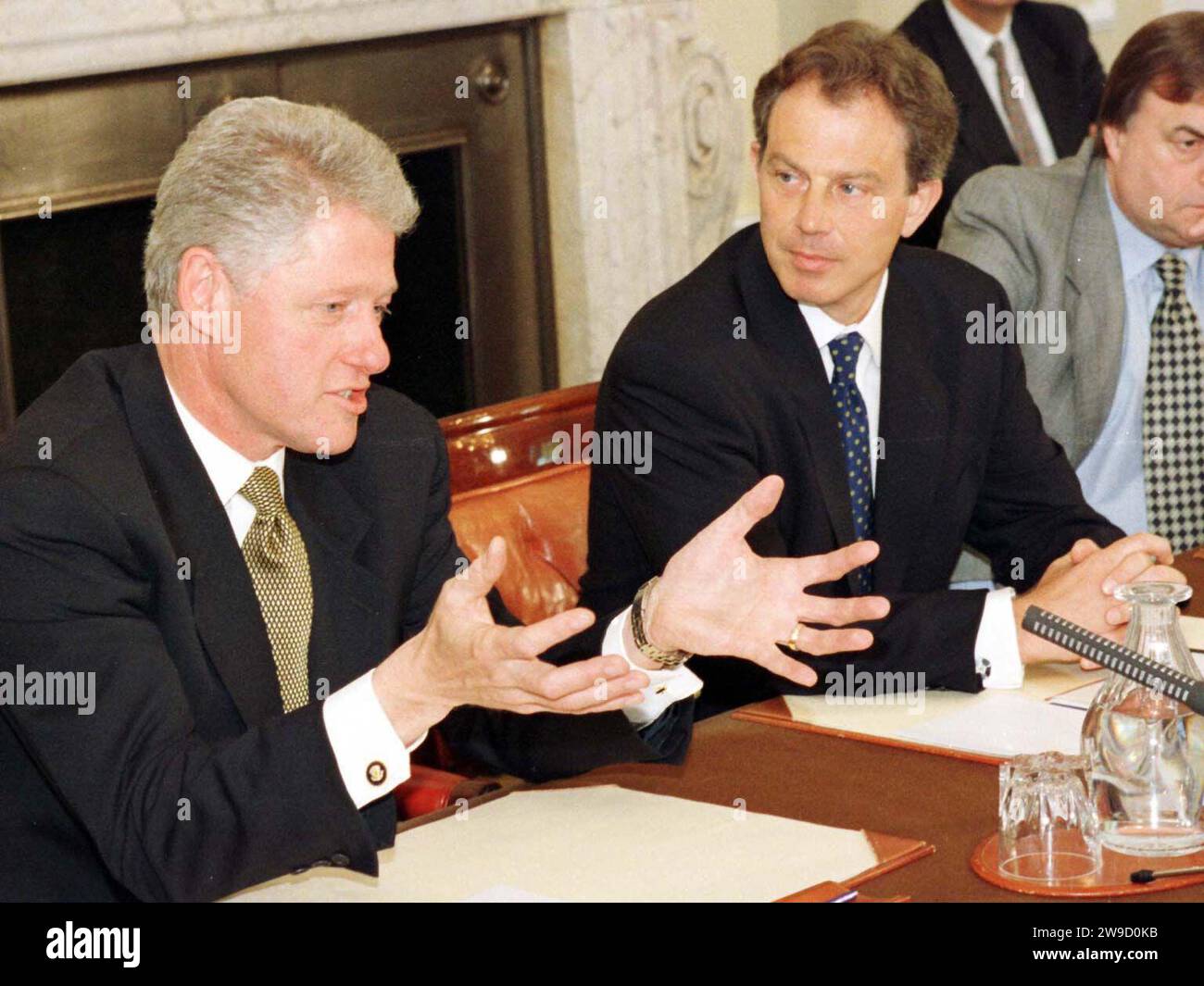 File photo dated 2/4/1998 Britain's Prime Minister Tony Blair looks at American President Bill Clinton who gestures while addressing the cabinet after their regular Thursday meeting at 10 Downing Street in London. Clinton was 'taken aback' during a phone call with Blair in which he conveyed that decommissioning would not take place by the Good Friday Agreement (GFA) deadline. Issue date: Wednesday December 27, 2023. Stock Photo