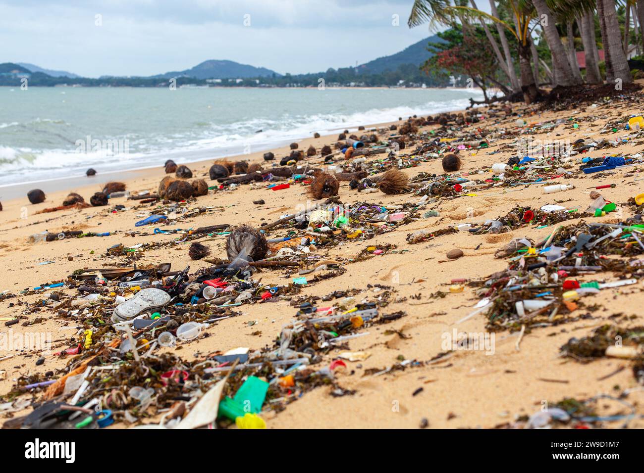 Garbage on sea beach, dirty ocean water, environmental pollution, ecological problem, waste management, junk recycle, unsorted rubbish, plastic Stock Photo