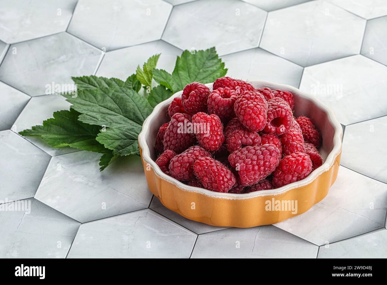 Rope sweet juicy raspberry heap in the bowl Stock Photo - Alamy