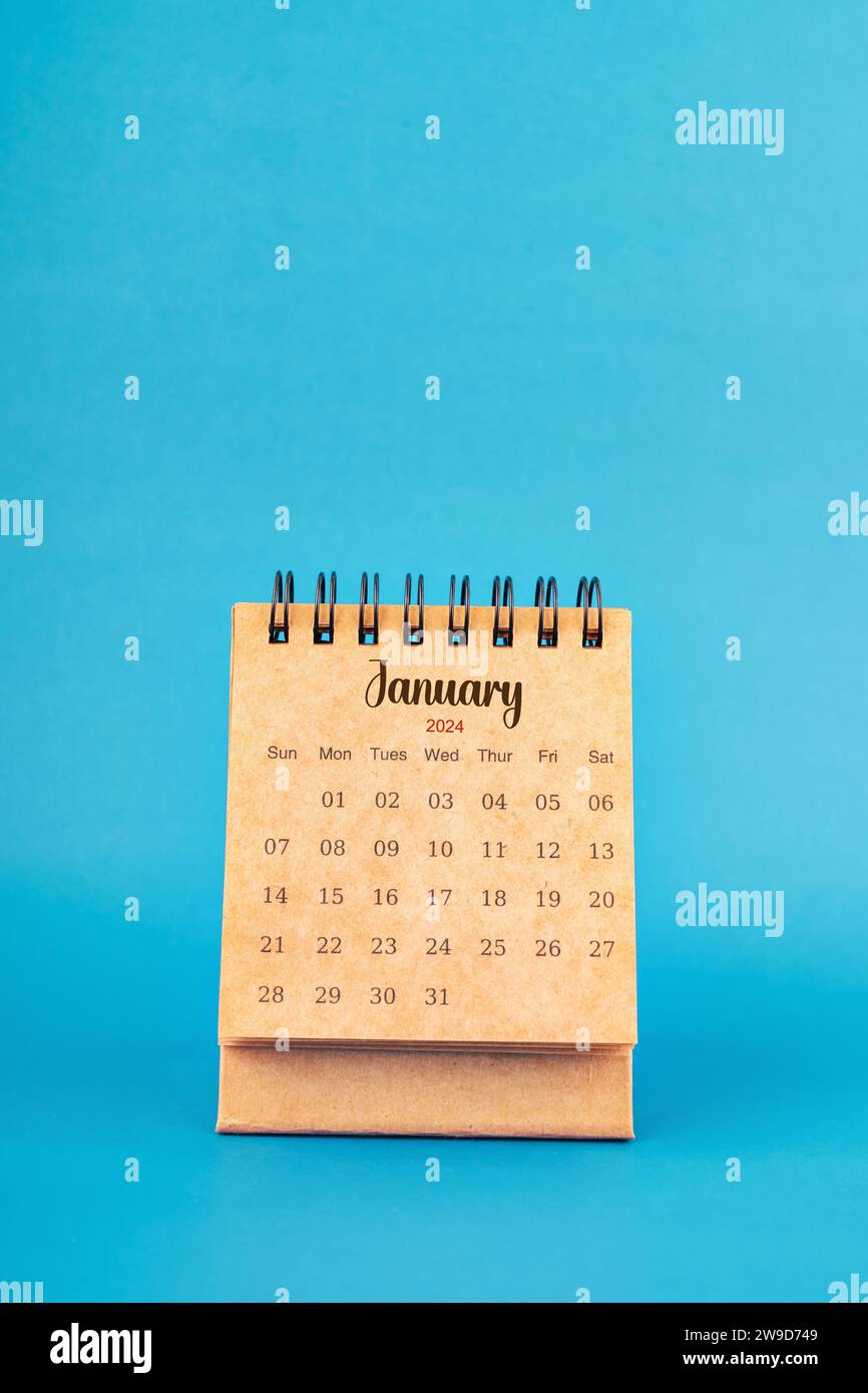 January 2024 white desk calendar on blue color background Stock Photo ...