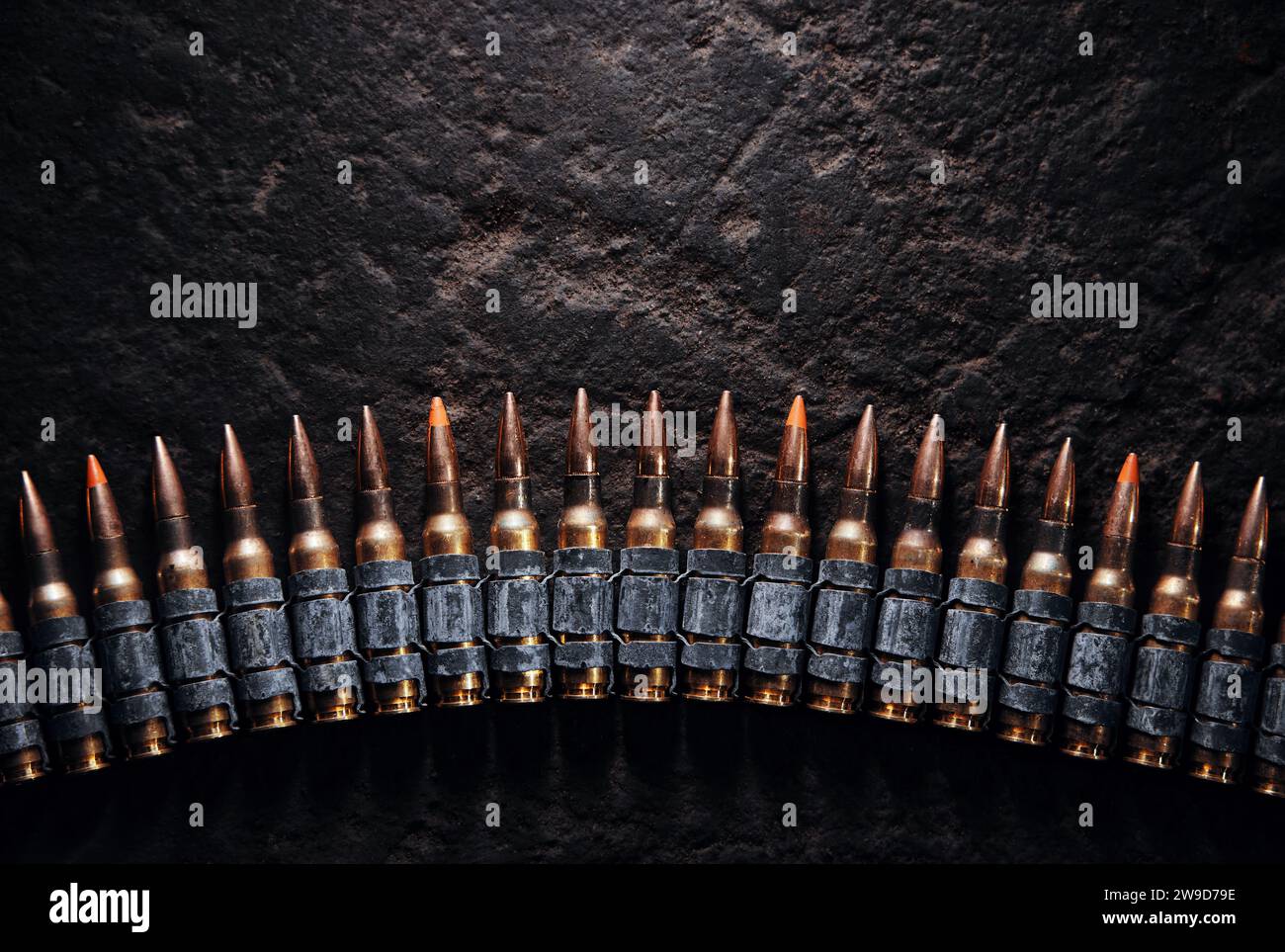 Machine gun bullet belt on the floor. Background on the military theme. Ammo, chain of ammo on concrete background. Top view of machine gun belt Stock Photo