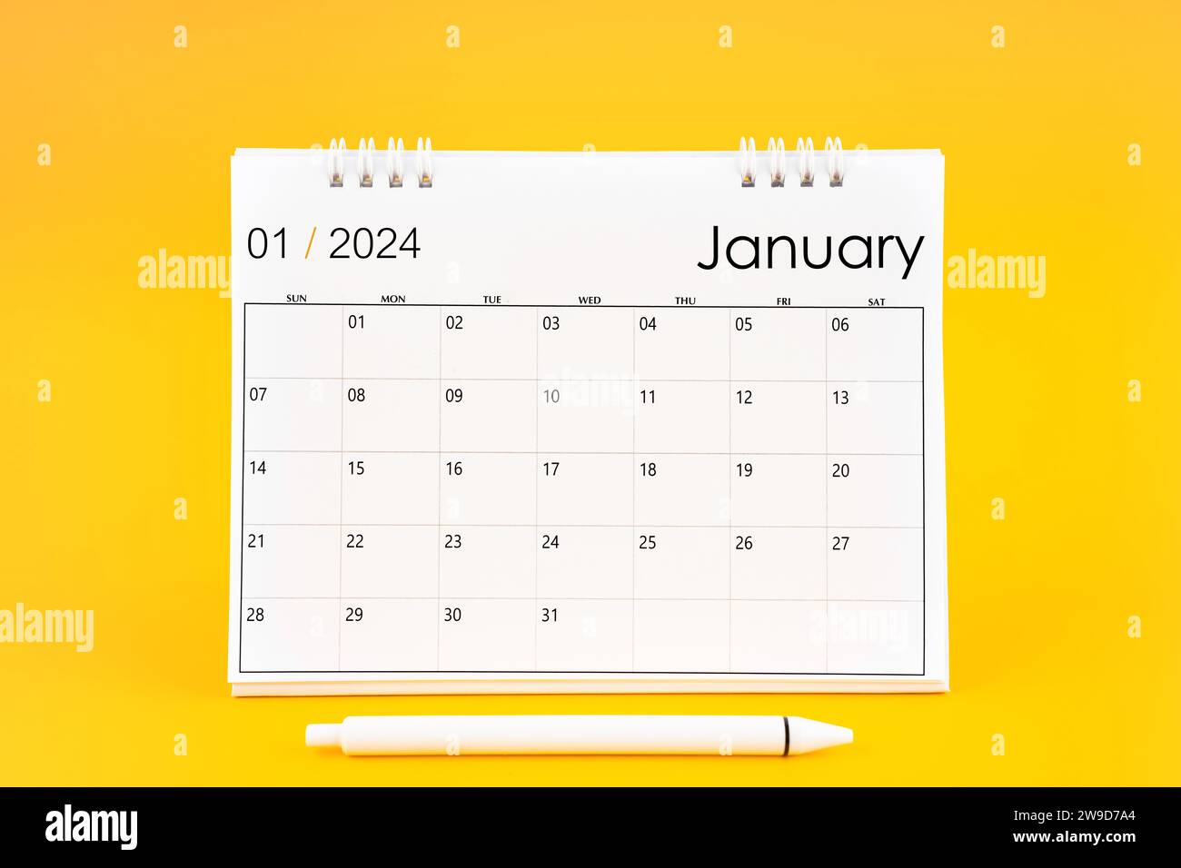 January 2024, Monthly desk calendar for 2024 year and pen on yellow ...