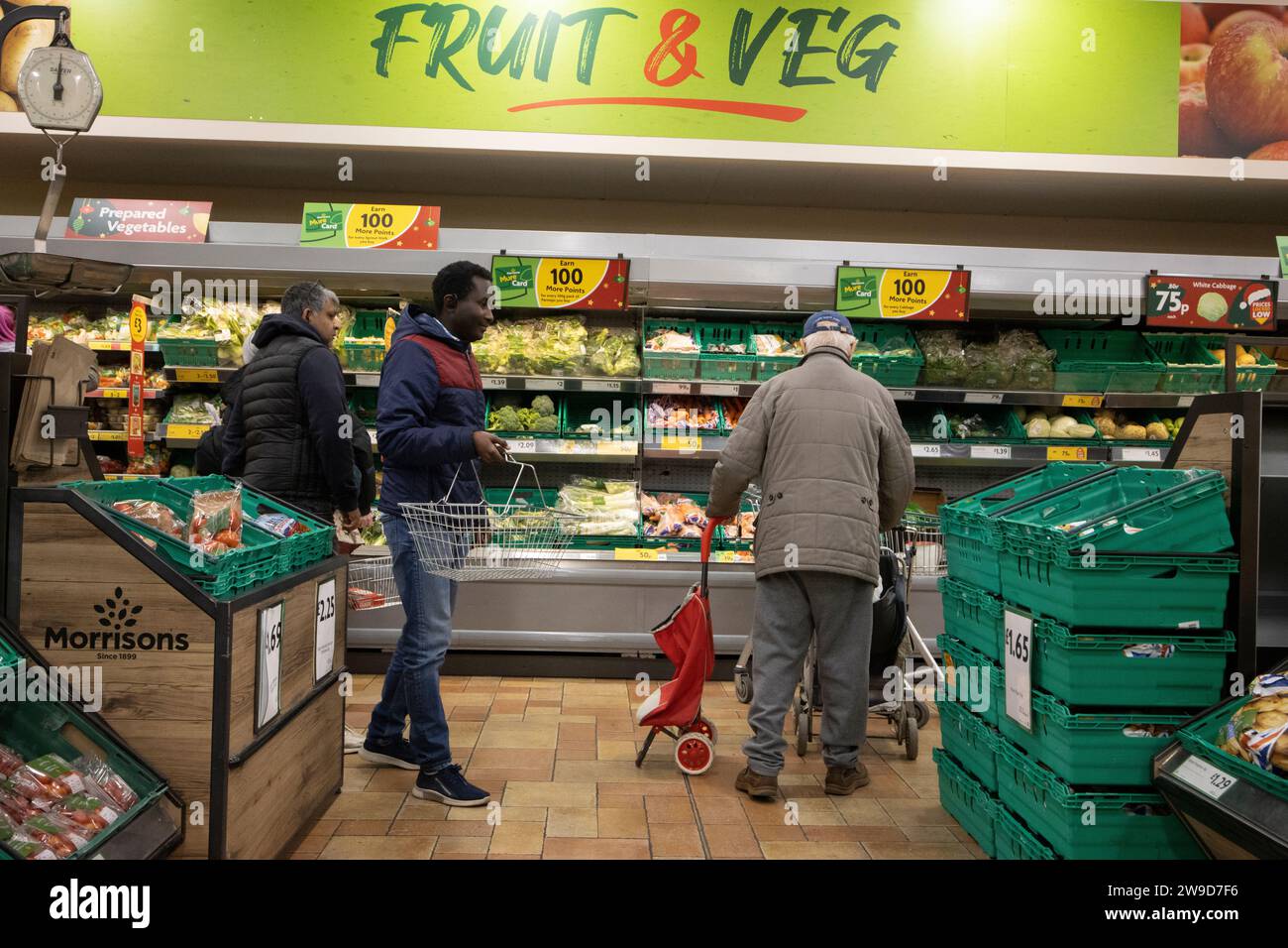 Shoppers at a Fruit & Veg aisle inside a Morrisons supermarket in central London, England, UK Stock Photo