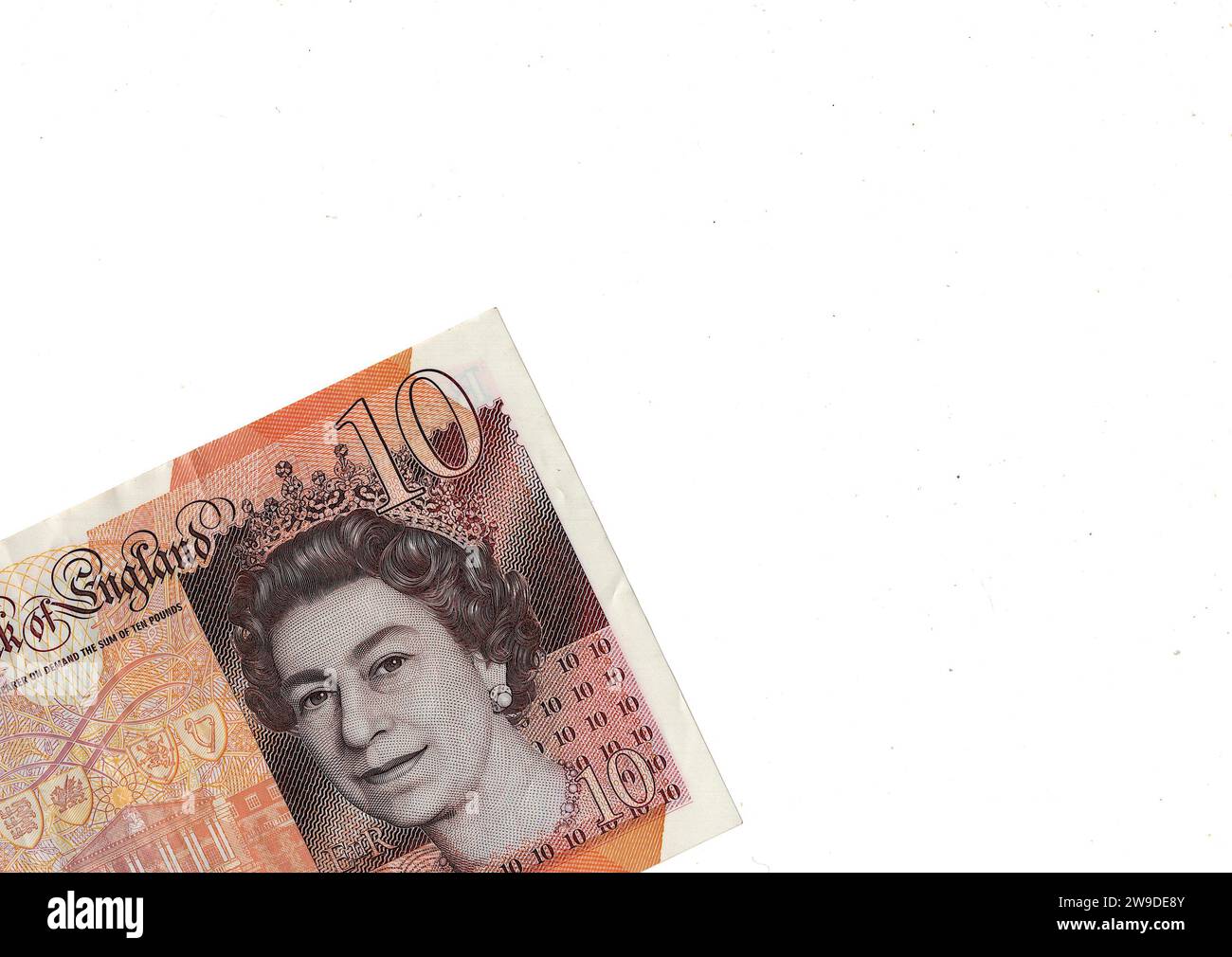Close up of a ten pound note featuring a portrait of Queen Elizabeth II  from the United Kingdom/Great Britain on a white background. Stock Photo