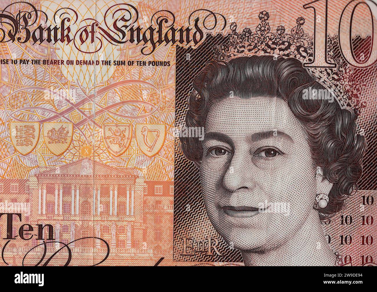 Close up of a ten pound note featuring a portrait of Queen Elizabeth II  from the United Kingdom/Great Britain on a white background. Stock Photo