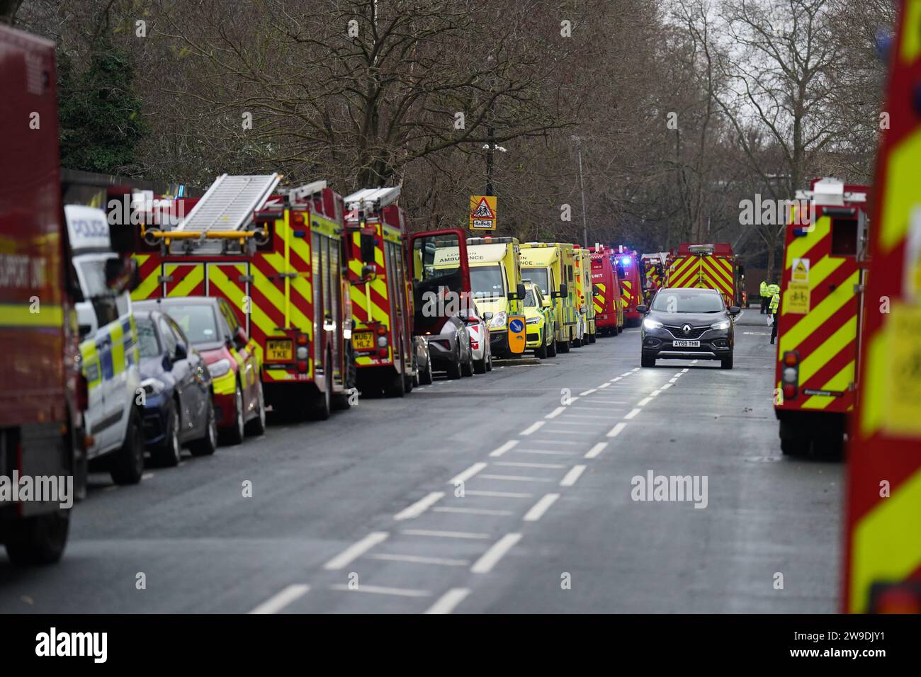 Fire engines and ambulances on Seagrave Road in Fulham, west London, as firefighters tackle a blaze at London Oratory School. An atrium is alight in the four storey building, the fire brigade said. Picture date: Wednesday December 27, 2023. Stock Photo