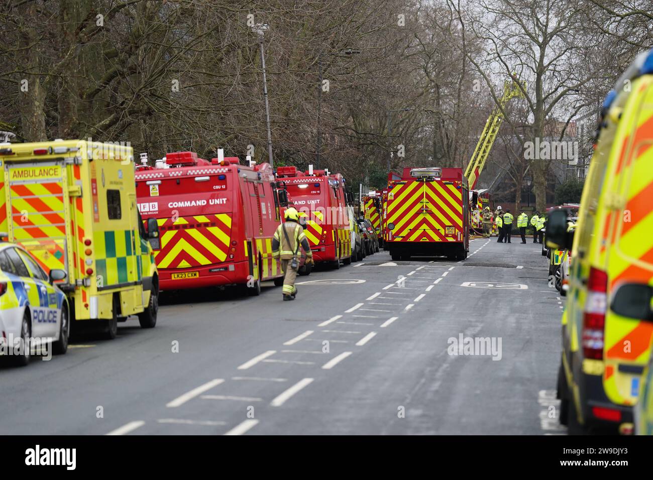 Fire engines and ambulances on Seagrave Road in Fulham, west London, as firefighters tackle a blaze at London Oratory School. An atrium is alight in the four storey building, the fire brigade said. Picture date: Wednesday December 27, 2023. Stock Photo