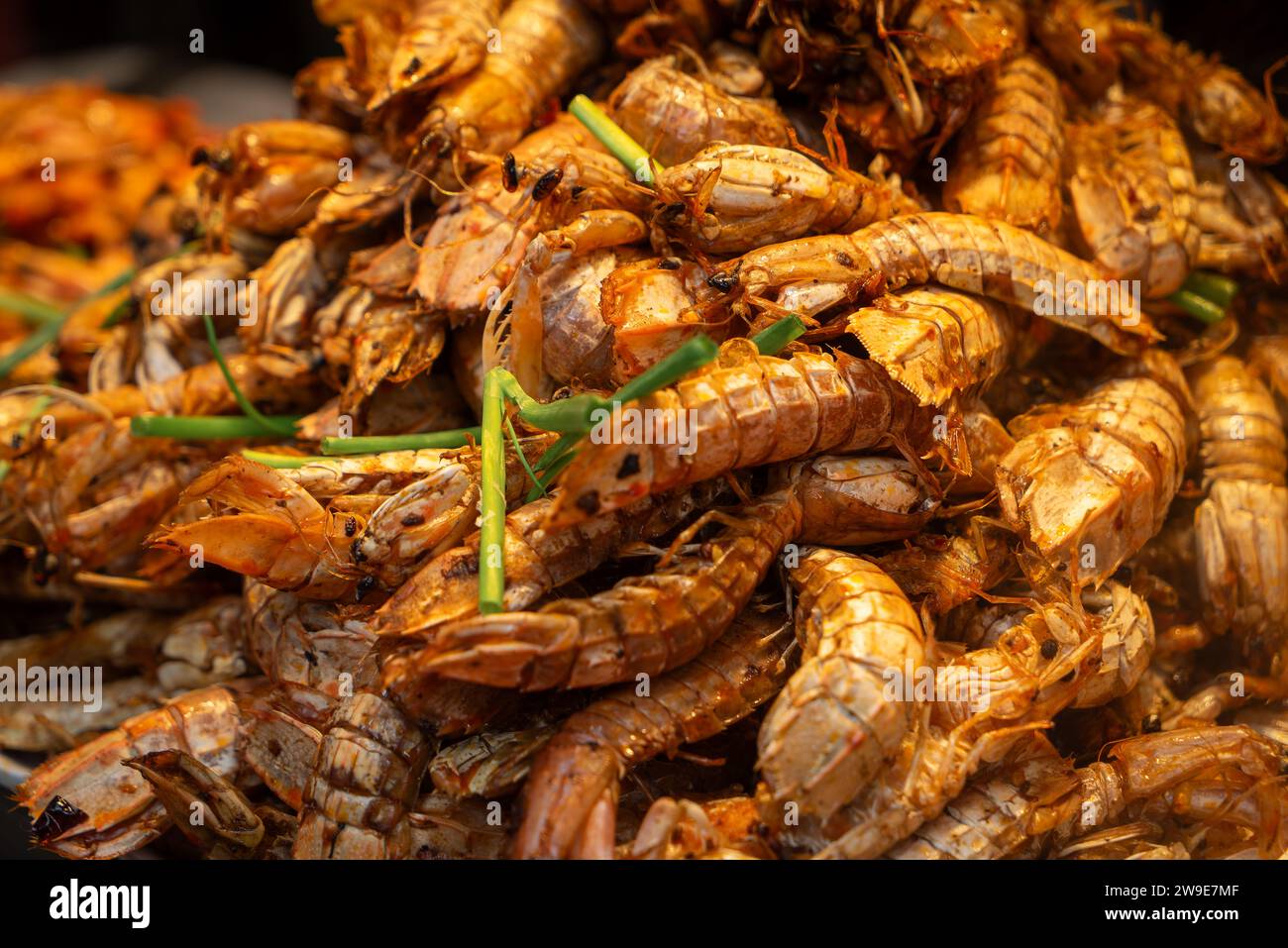 A pile of fresh mantis shrimp, a popular seafood dish in Wuchang , China. The shrimp are bright red and have a unique lobster appearance. Stock Photo