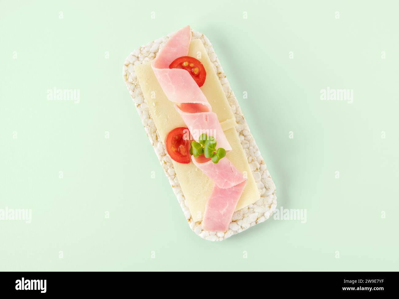 Oblong rice cake topped with ham and cheese Stock Photo