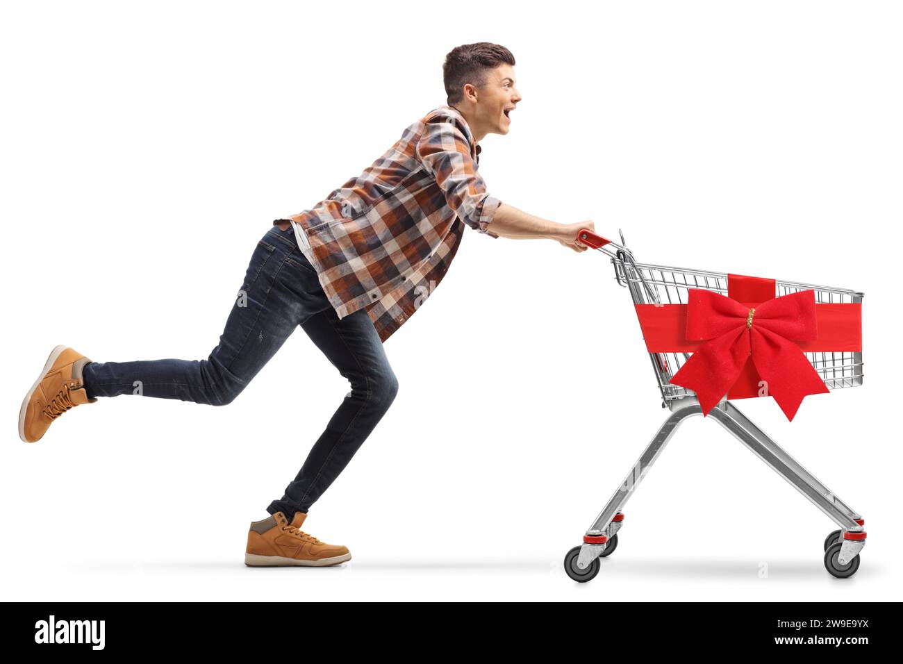 Young man running with an empty shopping cart tied with a red bow