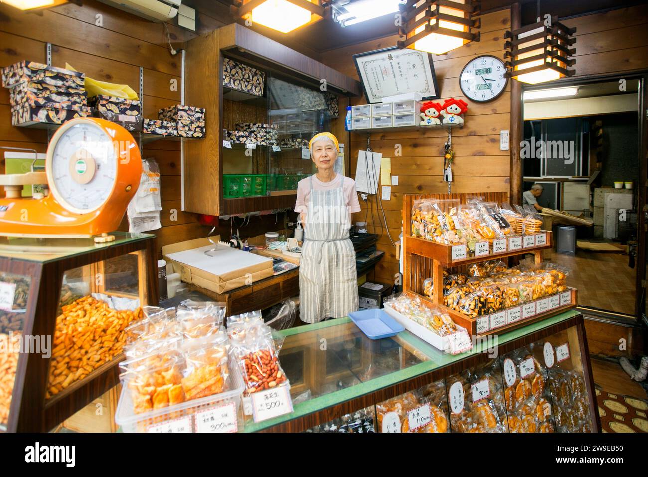 Tokyo, Japan 1st October 2023: Woman at the counter of a crispy rice cake shop in Yanaka in Japan. Stock Photo