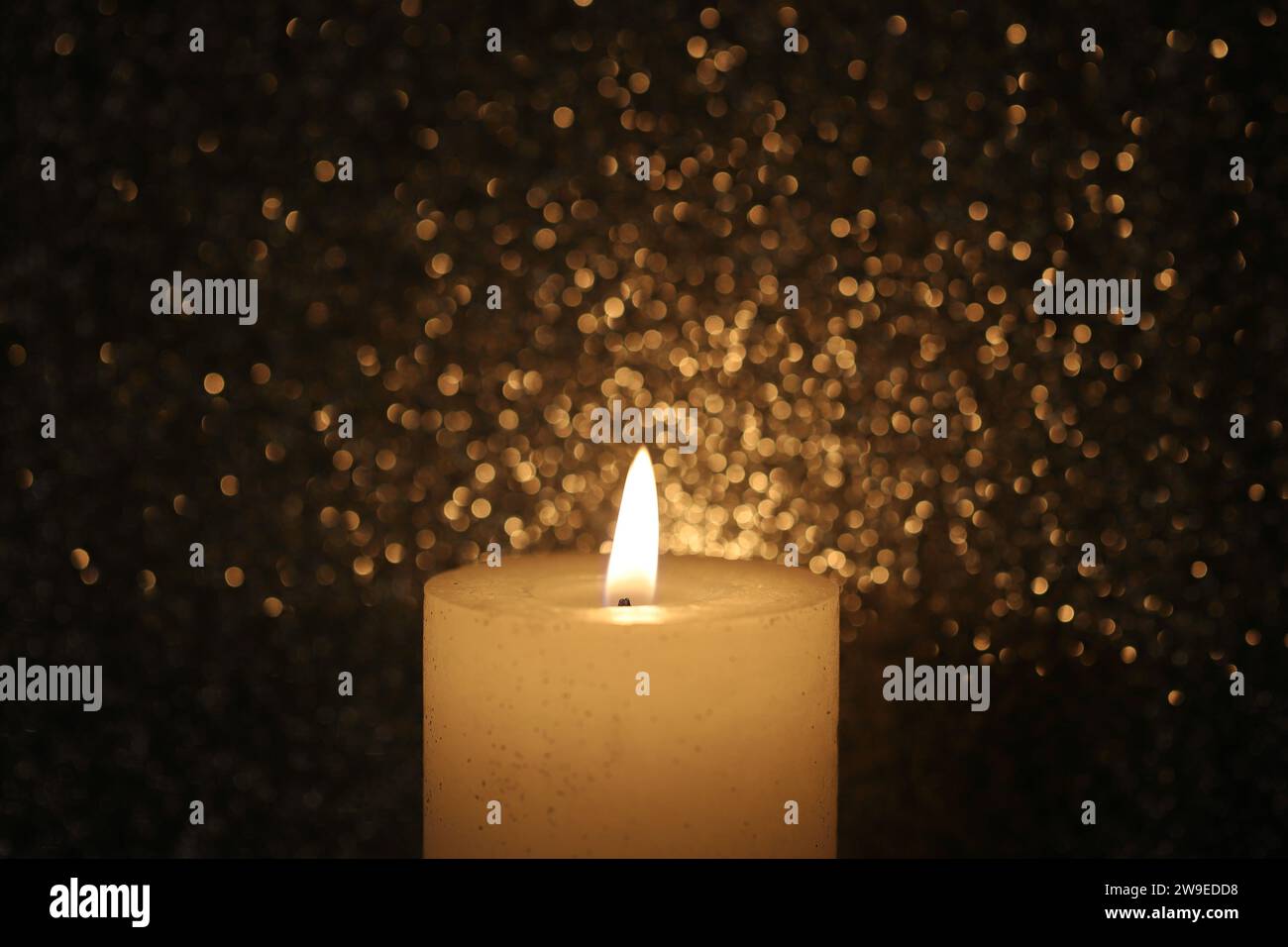 Pillar wax candle burning on white background Stock Photo - Alamy
