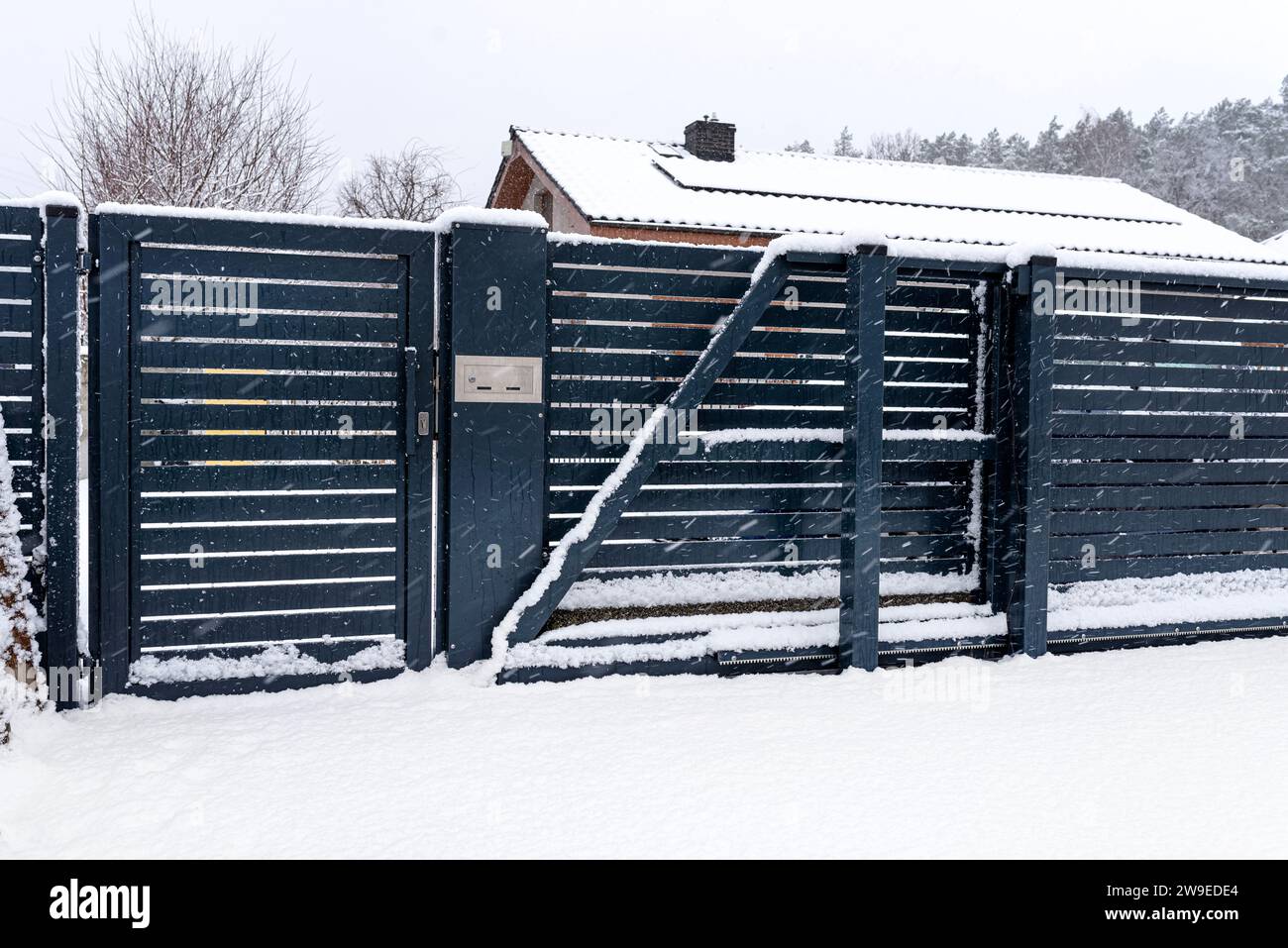 A modern gate with a letterbox and a wireless card reader, mounted in ...