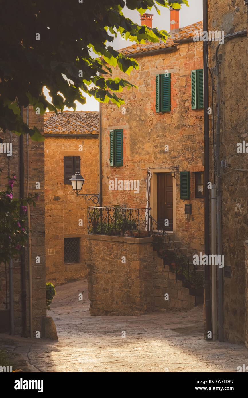 Charming and quaint narrow old town backstreet in in the historic Tuscan village of Monticchiello, Tuscany. Stock Photo