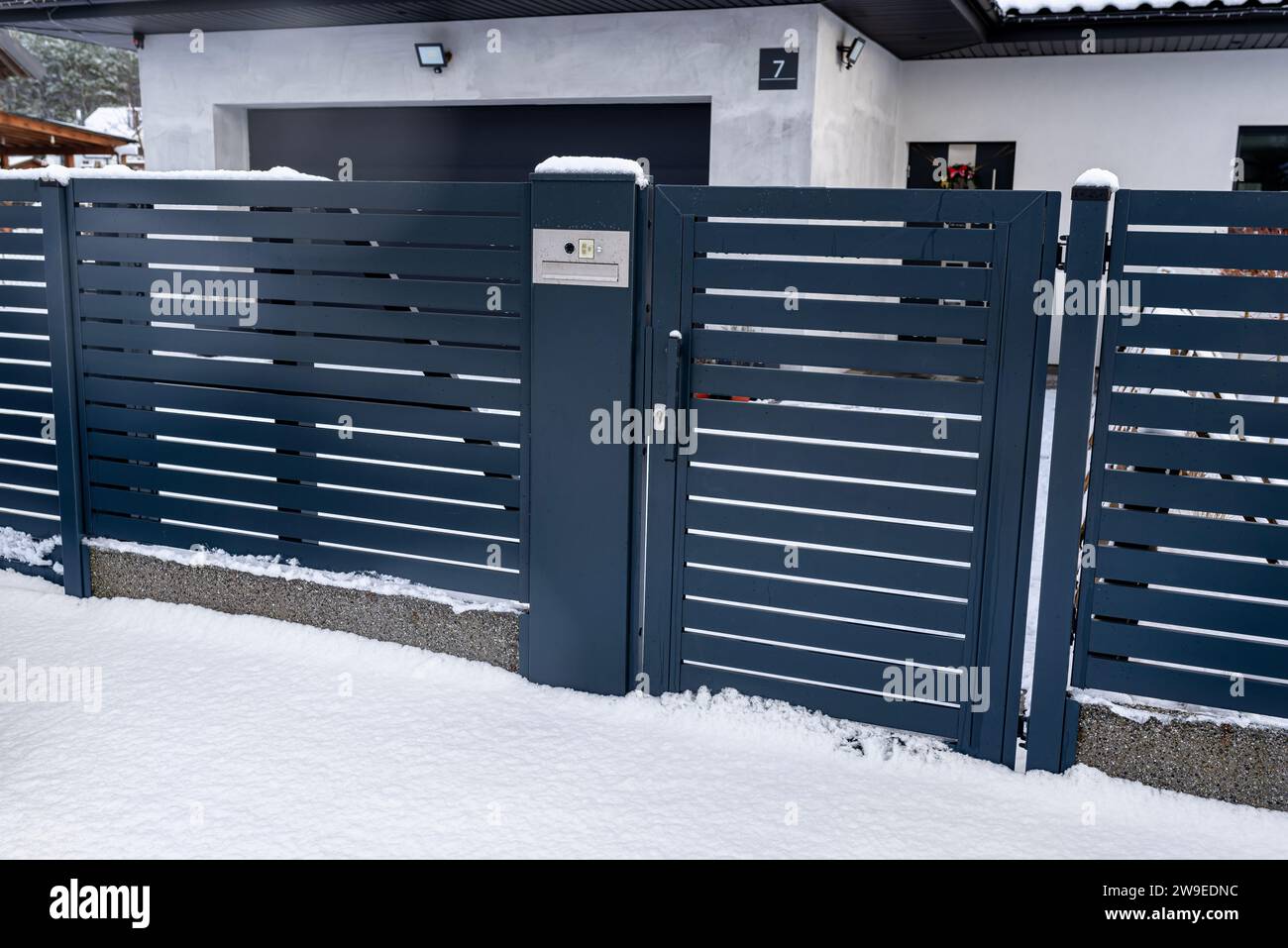 A modern gate with a letterbox and a wireless card reader, mounted in ...