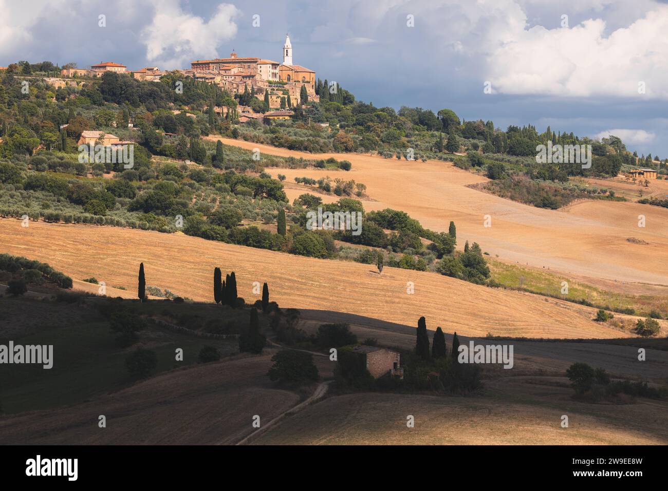 Scenic countryside landscape of rolling hills and farmland through Val d'Orcia and the historic hilltop village of Pienza in rural Tuscany, Italy. Stock Photo