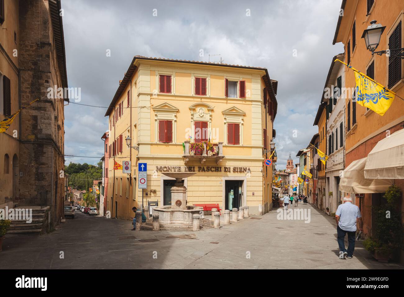 Asciano, Italy - August 30, 2023: Main street and old town centre of the quaint and charming, historic Tuscan village of Asciano, Tuscany. Stock Photo