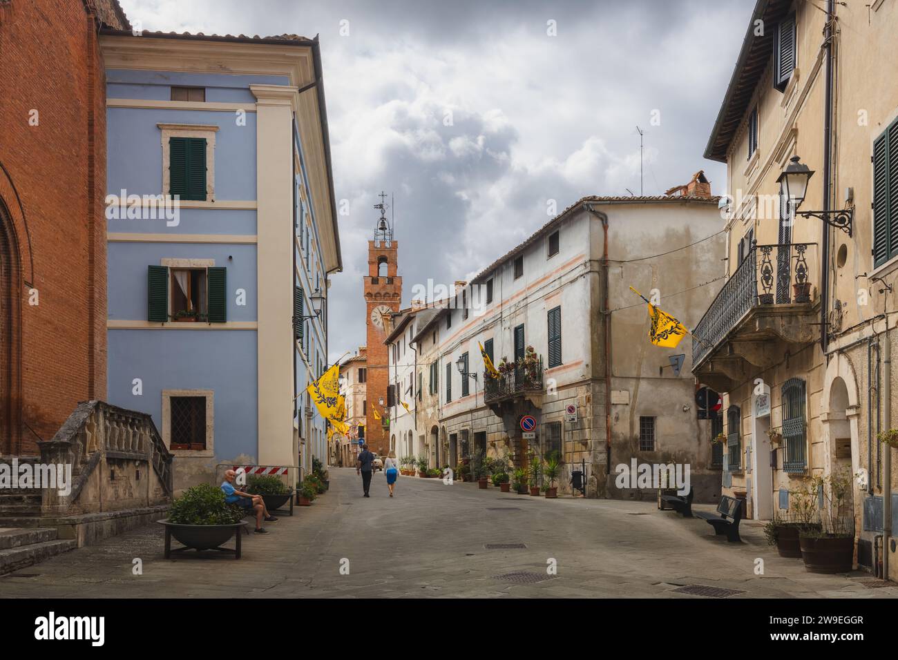 Asciano, Italy - August 30, 2023: Main street and old town centre of the quaint and charming, historic Tuscan village of Asciano, Tuscany. Stock Photo