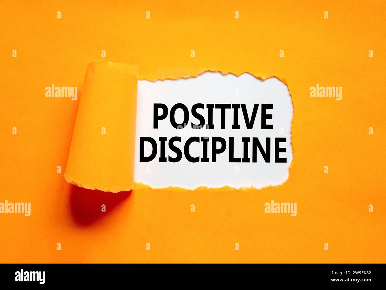 Positive discipline symbol. Concept words Positive discipline on beautiful white paper. Beautiful orange paper background. Business psychology positiv Stock Photo