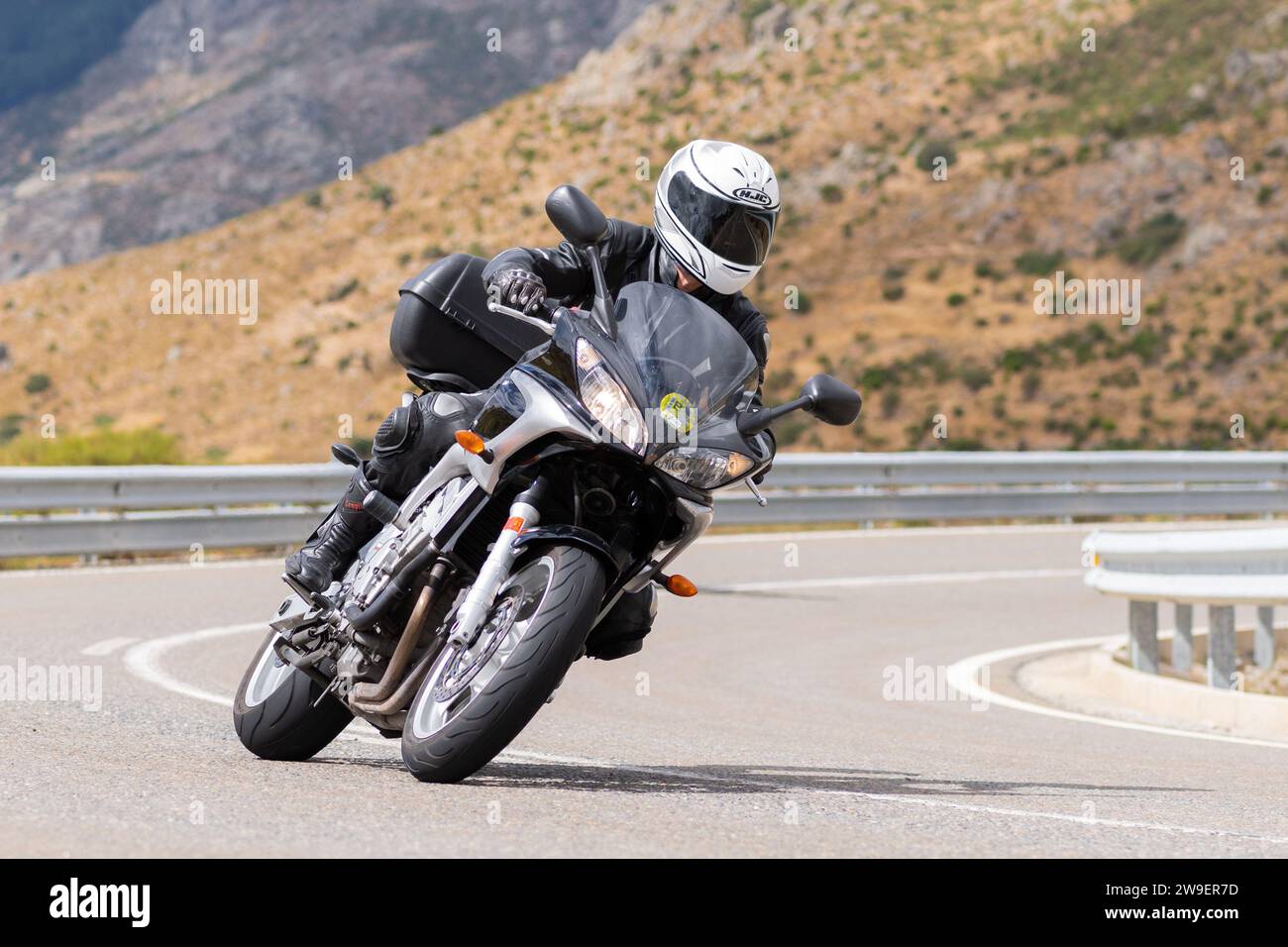 Motorcycle Sharp man on his motorcycle taking a sharp curve in the port of Navalmoral ...