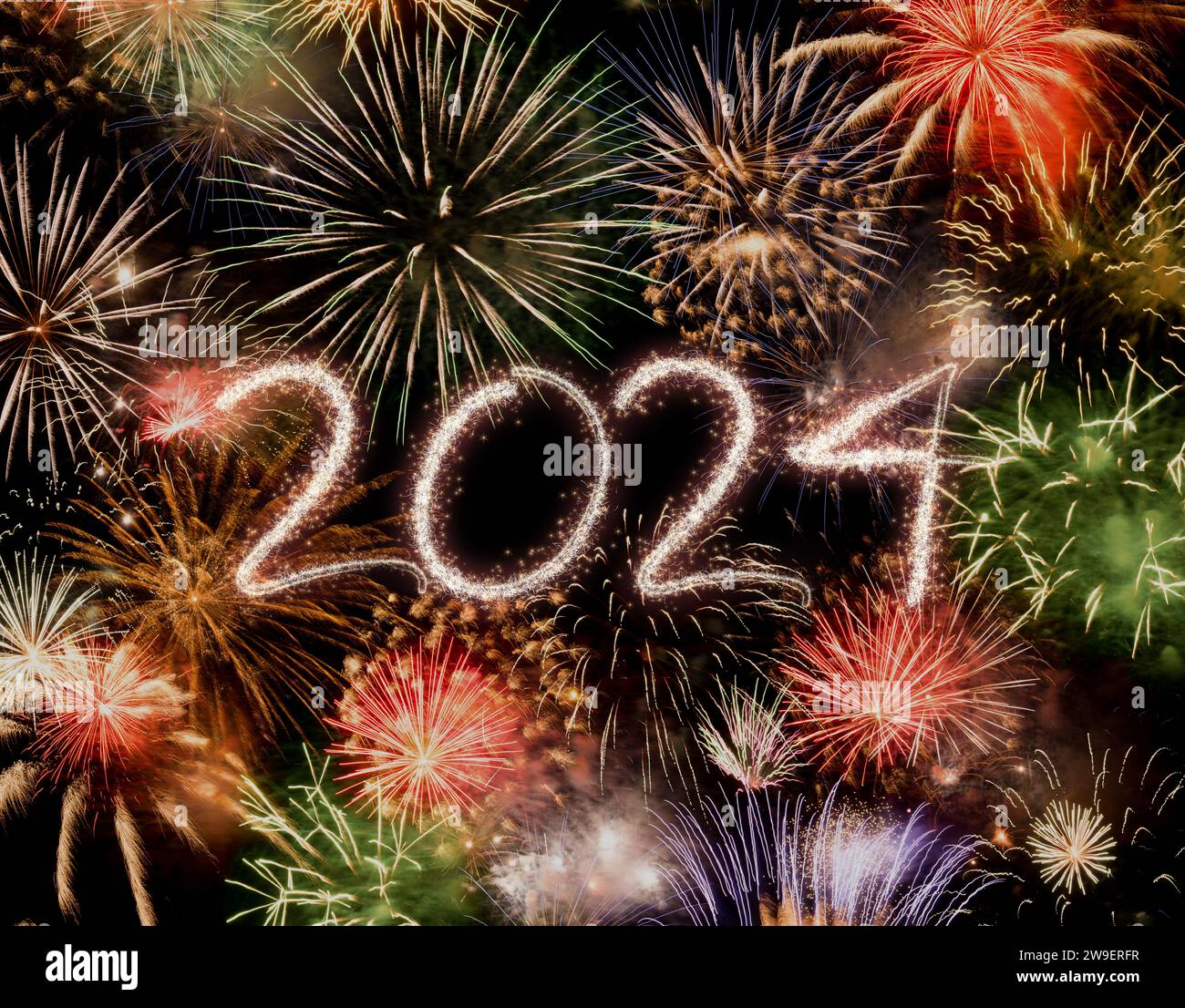 Stunning 2024 sparkler writing amidst vibrant fireworks explosion ...