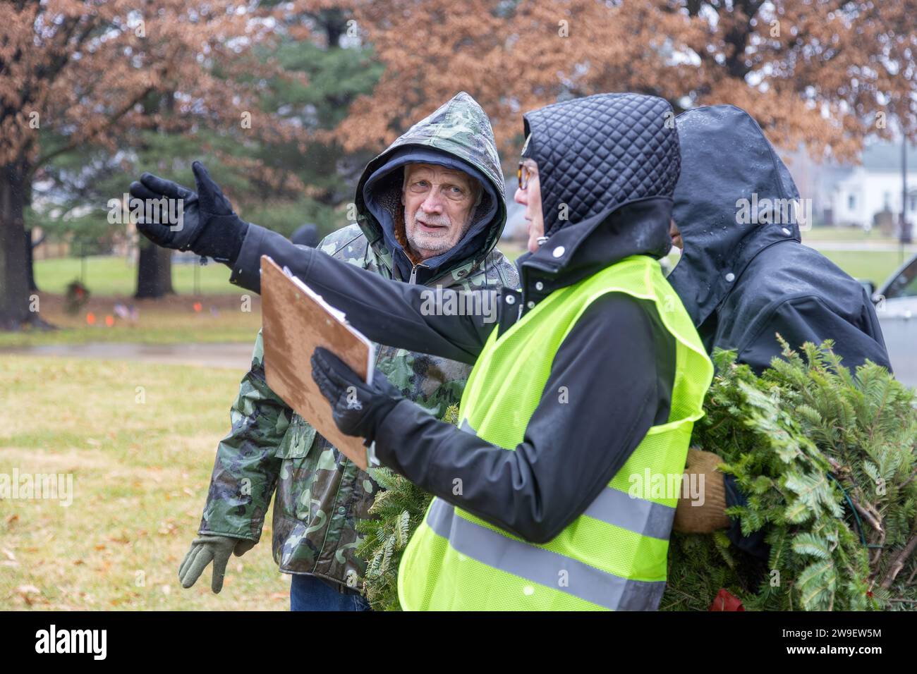 The Wreaths Across America Ceremony at Aspen Grove Cemetery in Burlington, Iowa. Volunteers receiving instructions on where to place wreaths. Stock Photo